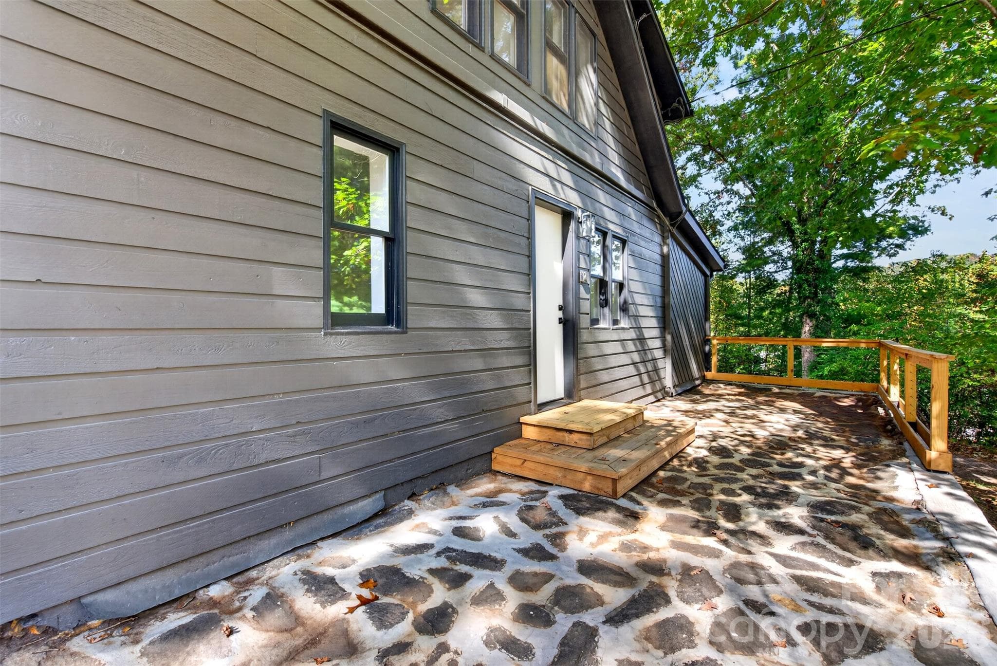 Restored stone patio with new handrail - 64 Pine Cone Drive, Asheville