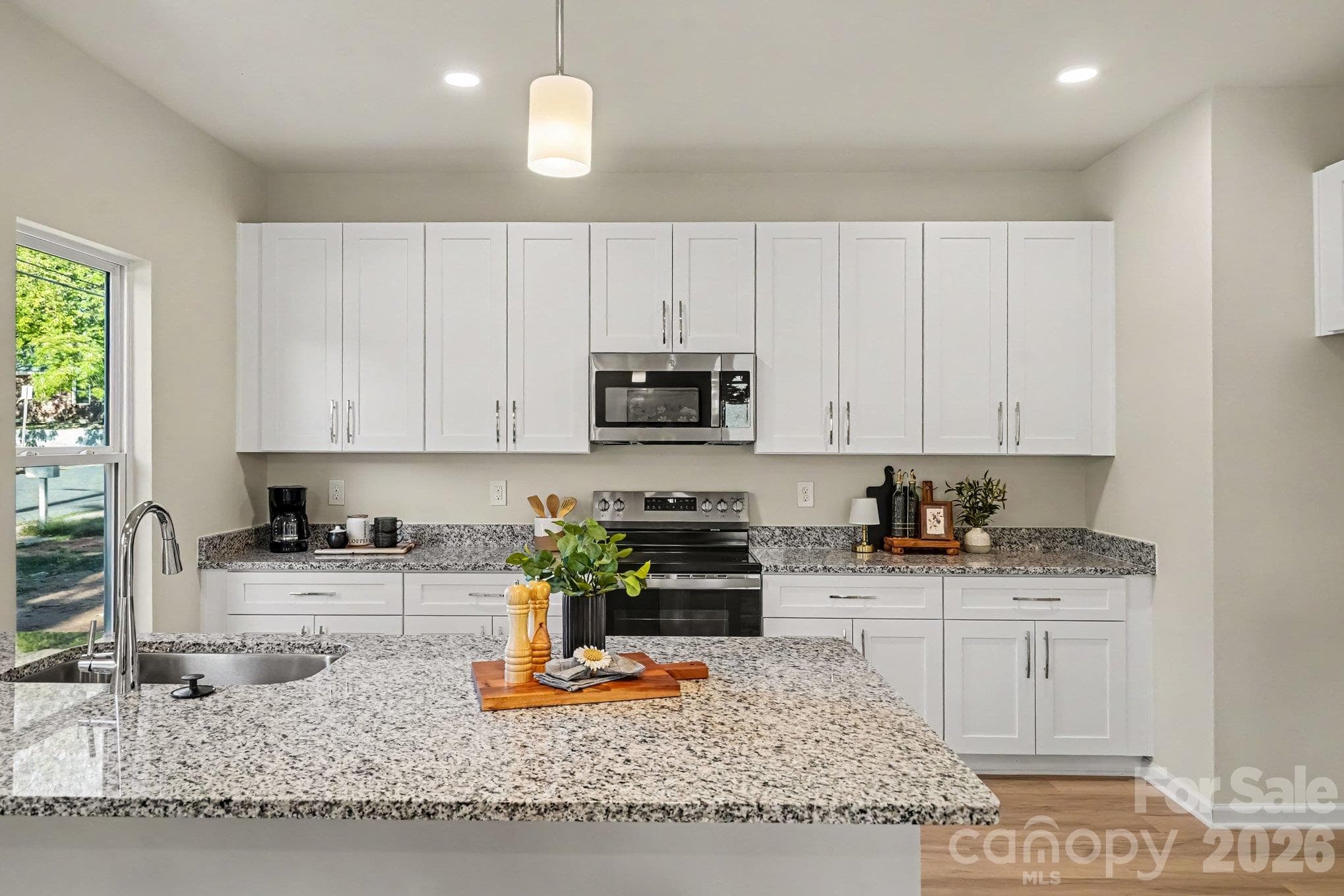 Kitchen has electric range, microwave, disposal and dishwasher. The sink is a farm style stainless steel type. Beautiful granite countertops. - 121 Buffalo Avenue NW, Concord