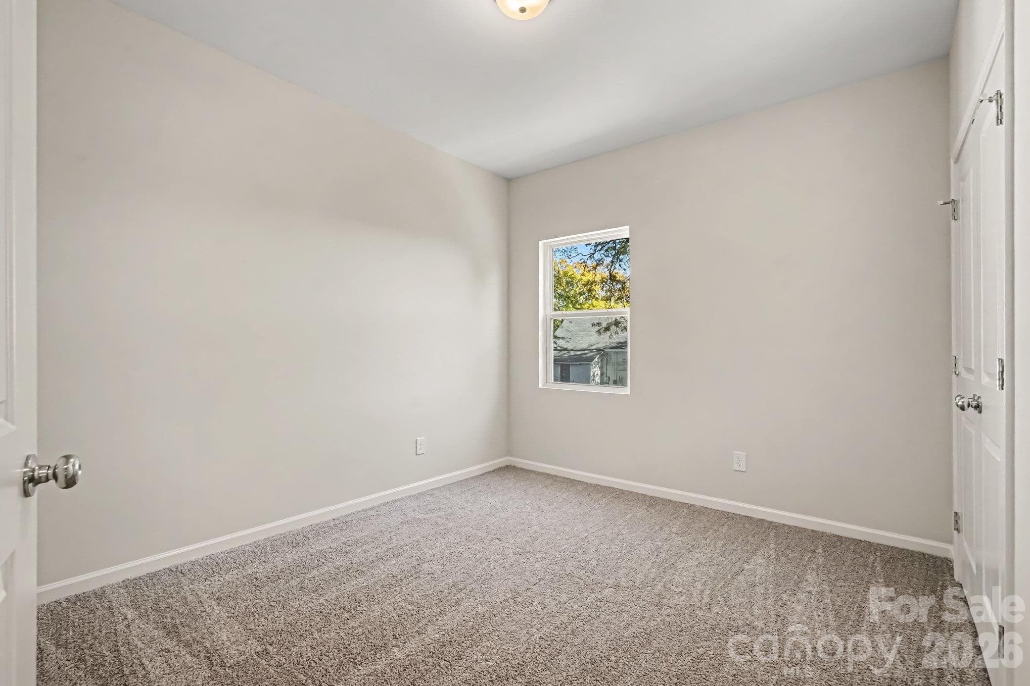One of three bedrooms on upper level has carpeted flooring. - 121 Buffalo Avenue NW, Concord