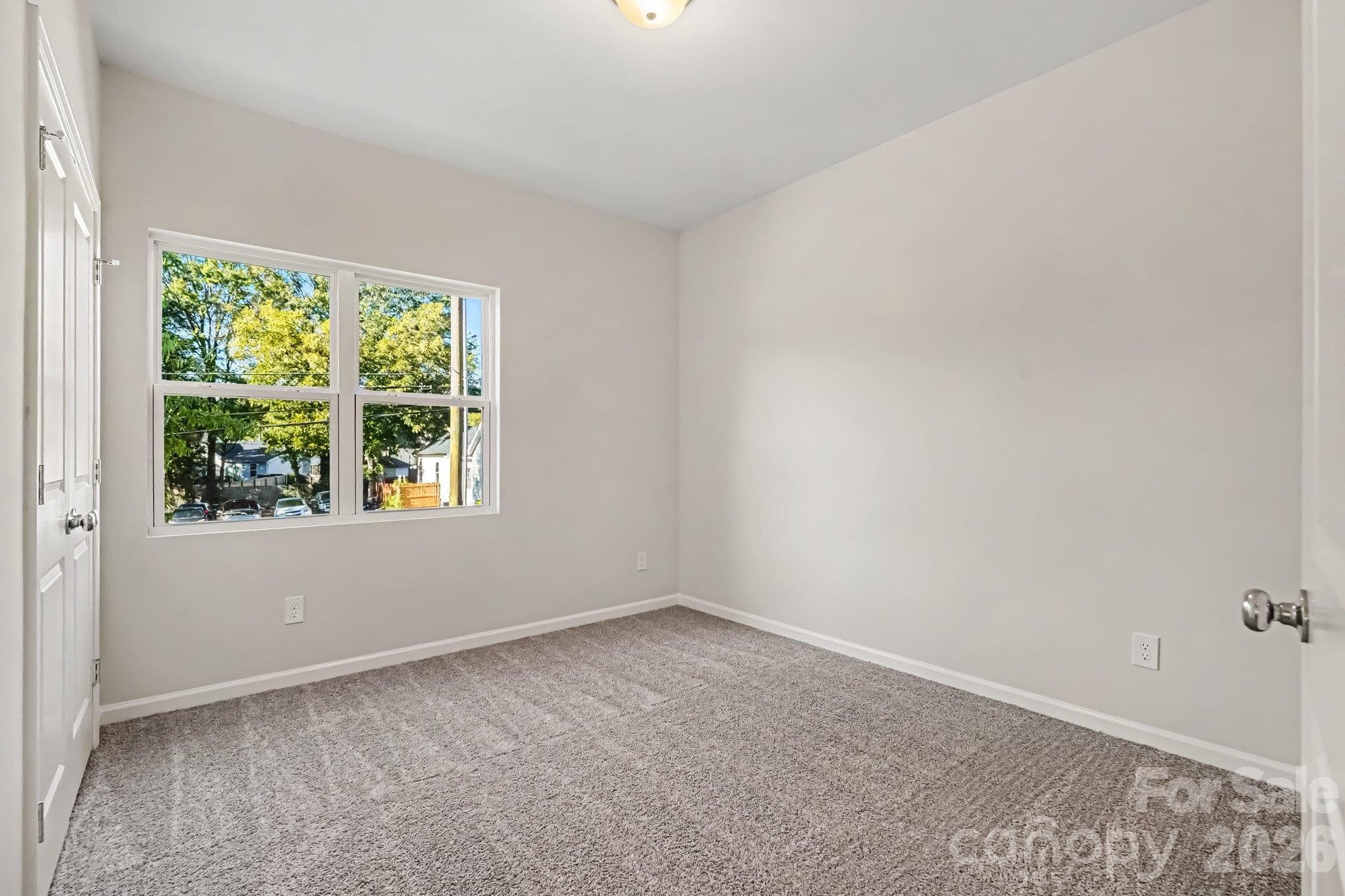 One of three bedrooms has carpeted flooring. - 121 Buffalo Avenue NW, Concord