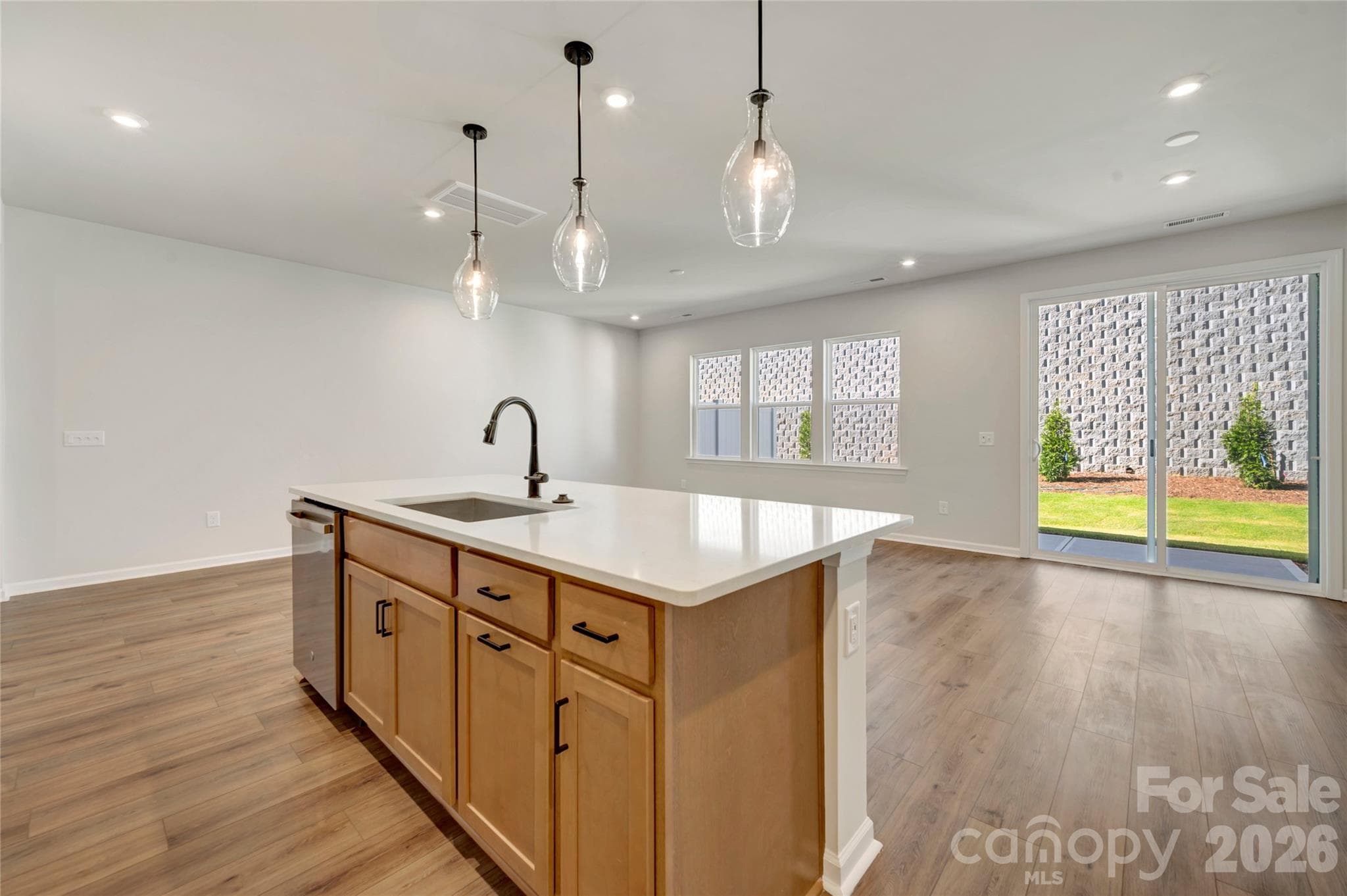 Kitchen island with a large single bowl stainless steel sink and a dishwasher - 707 Bowery Place, Cramerton