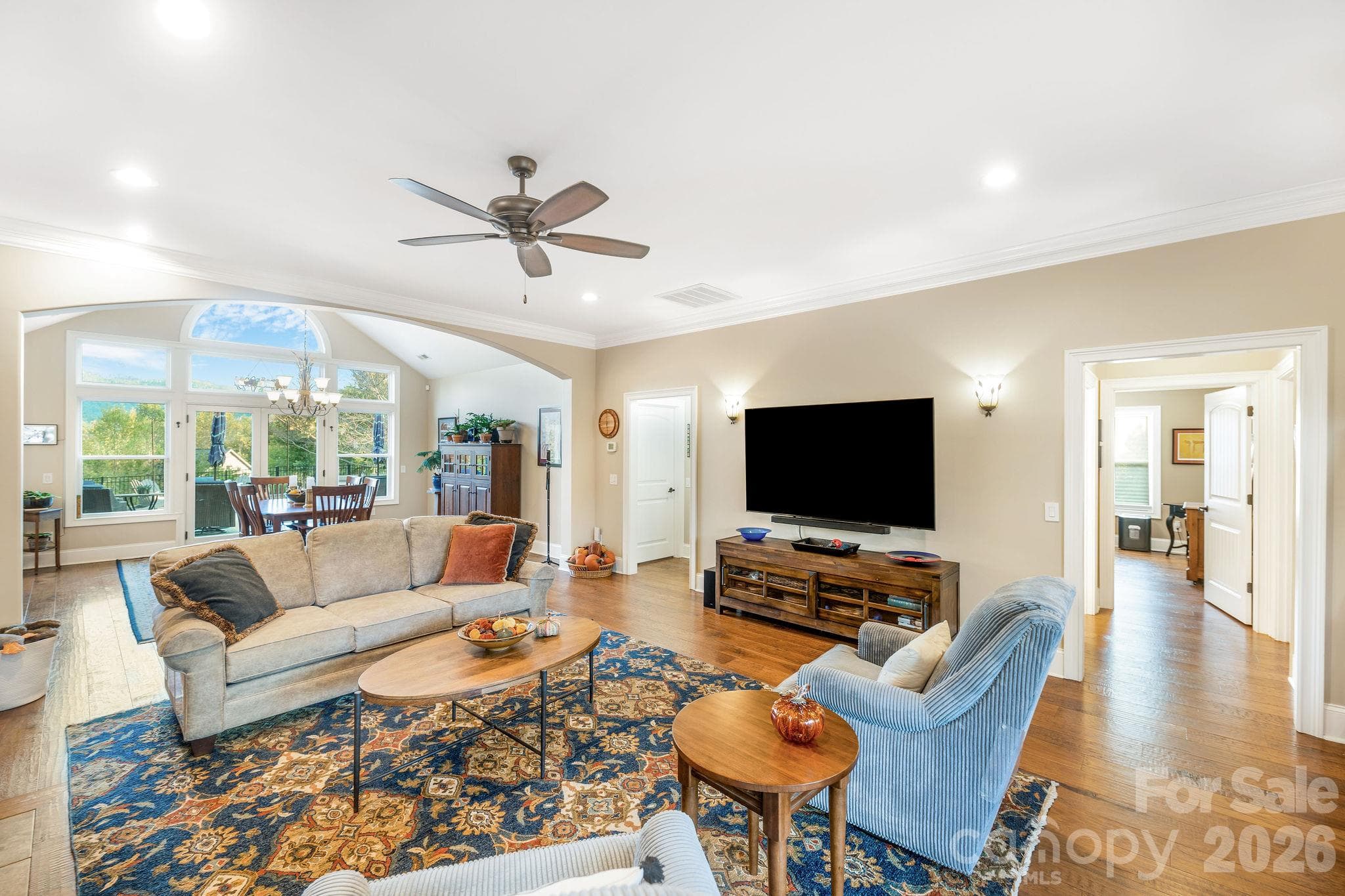 Open-concept living area with seamless flow into the dining room and kitchen - 28 Penley Park Drive, Weaverville