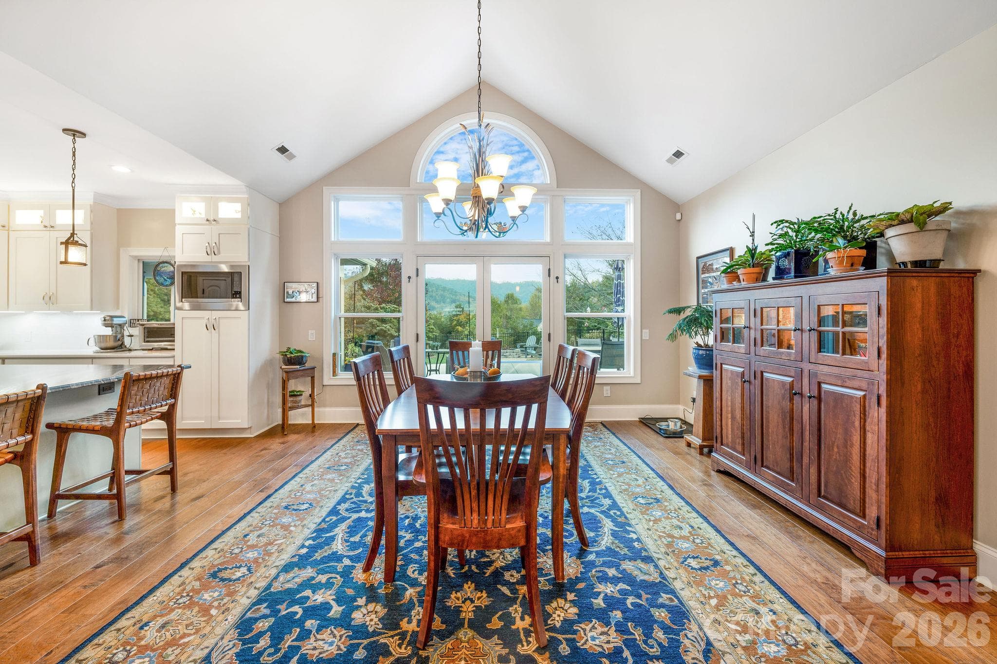 Light-filled dining room with vaulted ceiling and expansive mountain-view windows - 28 Penley Park Drive, Weaverville