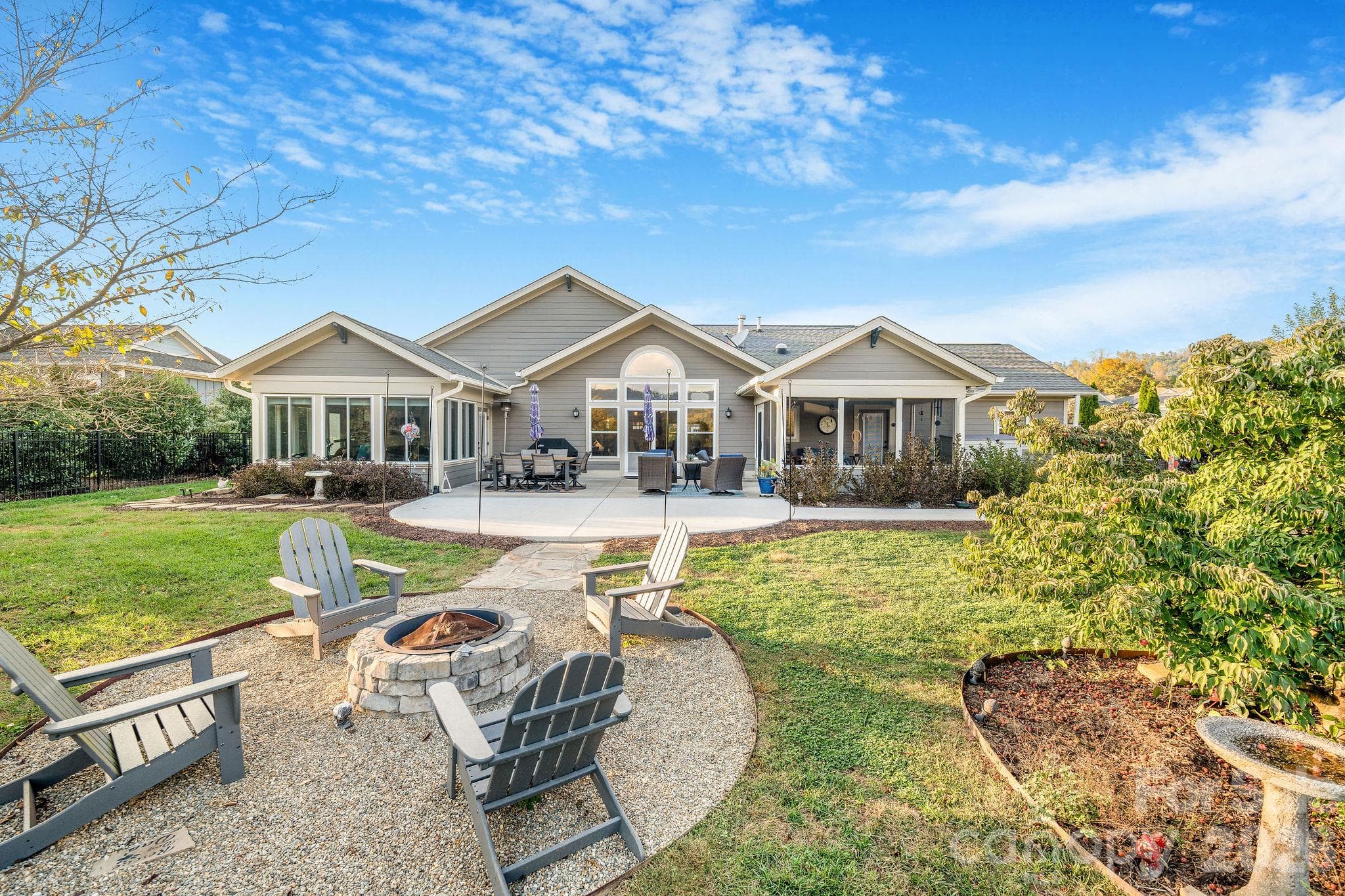Expansive backyard featuring a fire pit, spacious patio, and outdoor entertaining areas - 28 Penley Park Drive, Weaverville