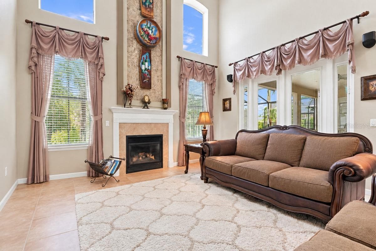 Two story living room is anchored by the fireplace feature wall. - 2631 TREYMORE DR, ORLANDO