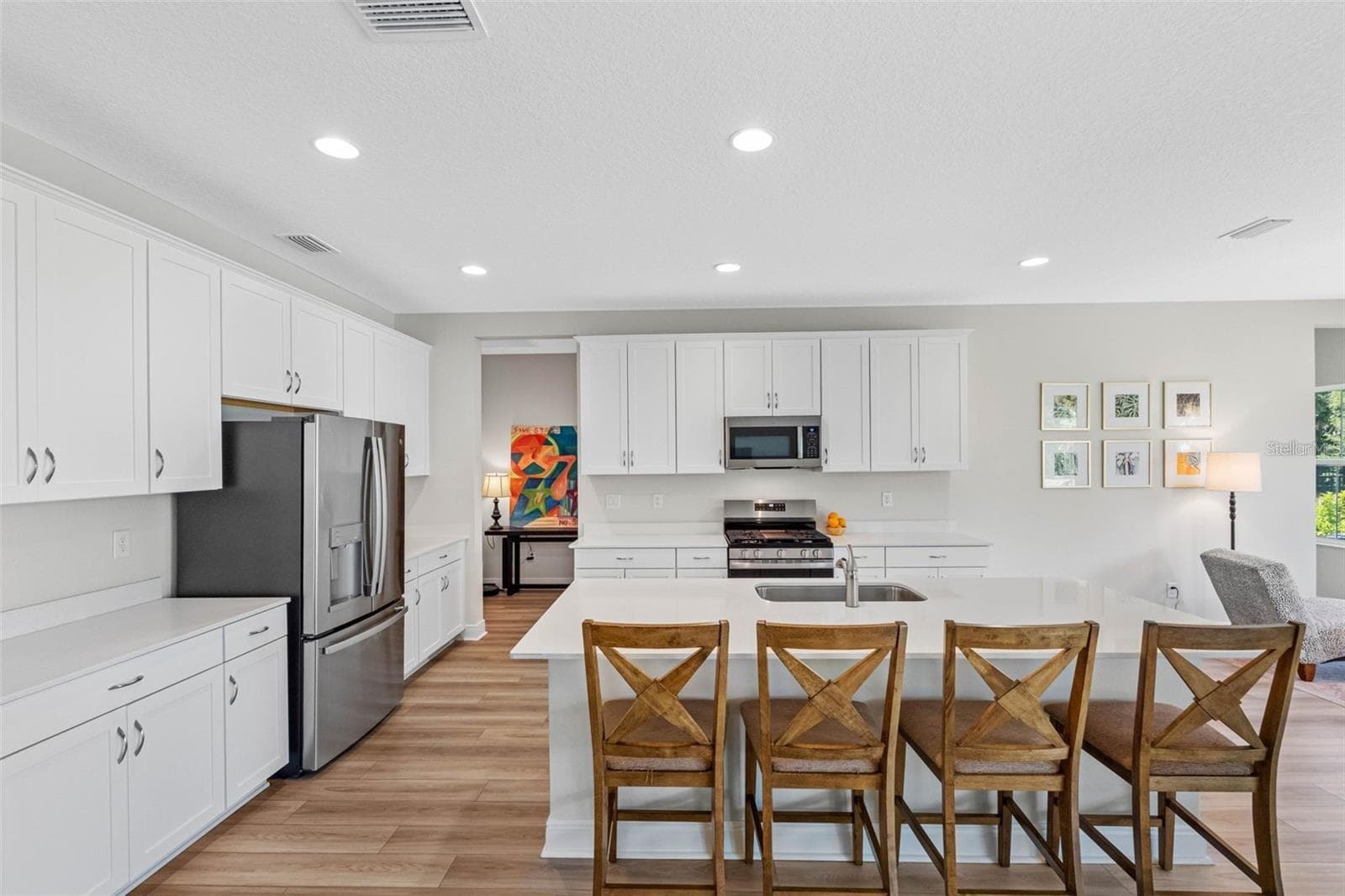 Kitchen with quartz countertops, a seating island, and a gas range - 14868 SUMMER BRANCH DR, LITHIA