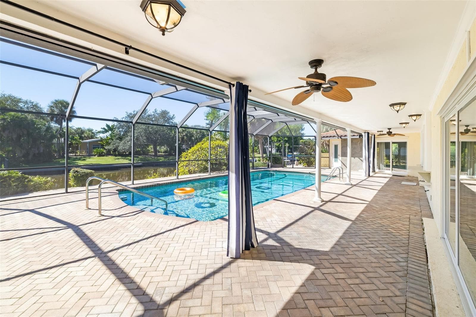 Covered area on patio overlooking pool and canal - 5456 AZURE WAY, SARASOTA