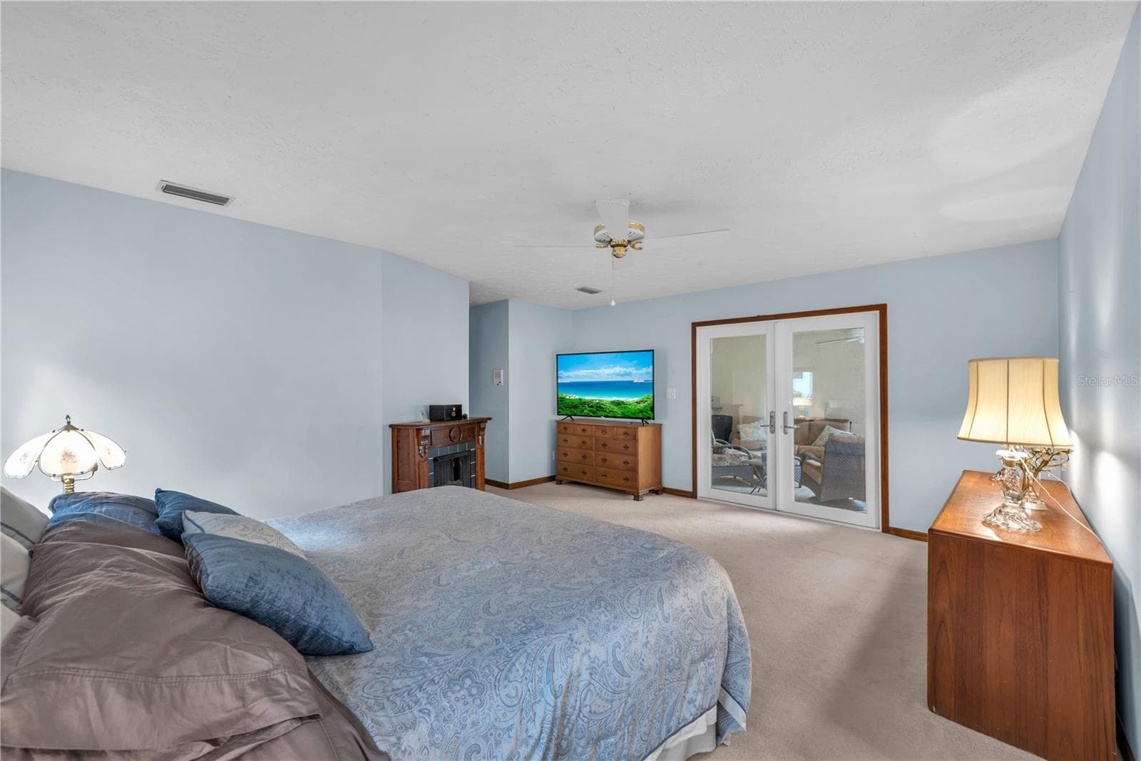 The expansive primary suite is a retreat of its own, complete with French doors opening directly to the screened lanai. - 2421 OAK LANDING DR, BRANDON