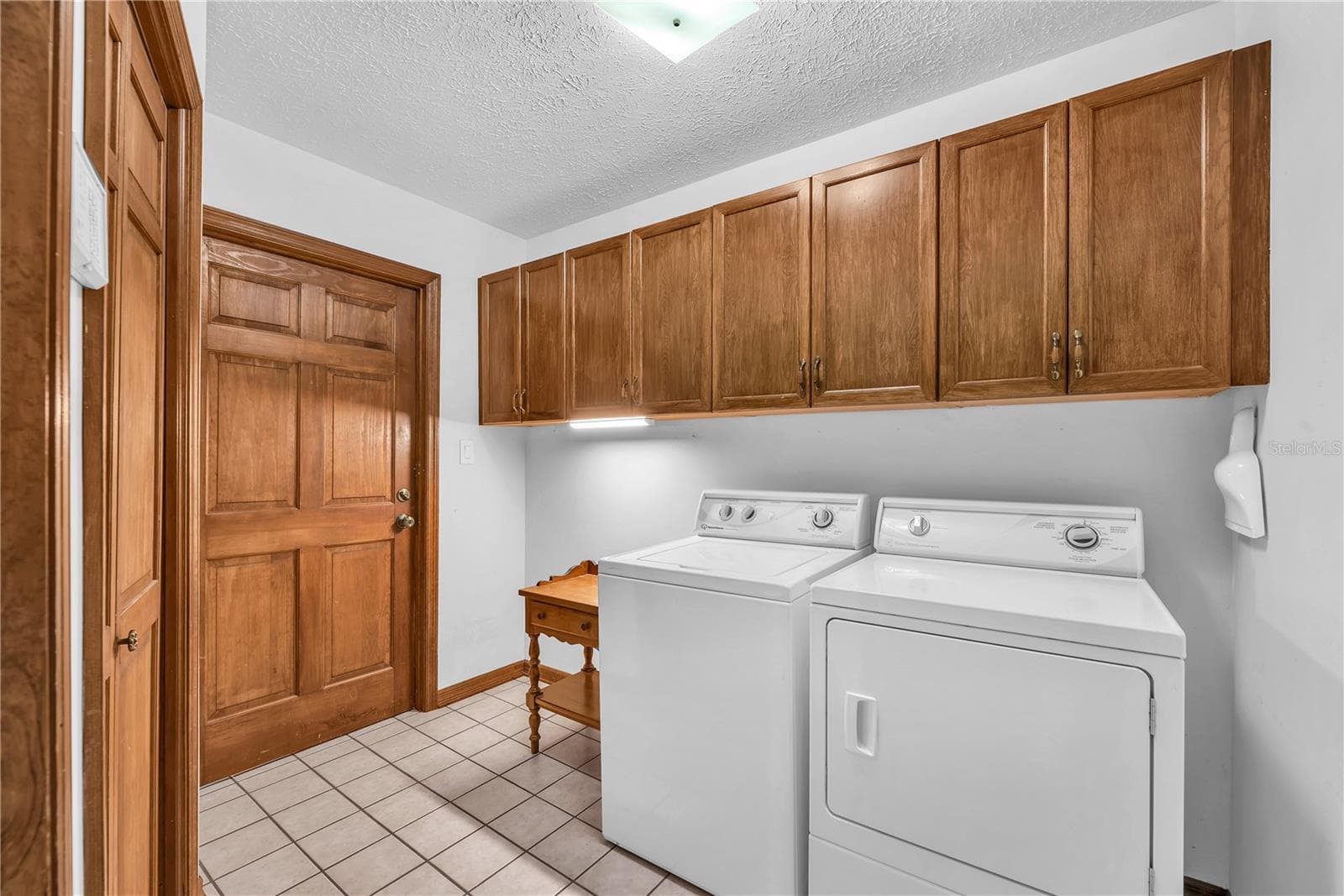 Spacious Laundry room with lots of cabinet storage and garage access. - 2421 OAK LANDING DR, BRANDON