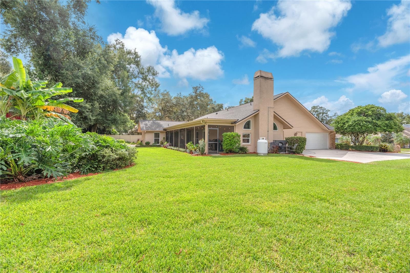 An expansive driveway provides ample off-street parking, while the oversized side-entry garage includes a dedicated workshop, offering plenty of space for projects, hobbies, and storage. Propane tank for cooking is leased. - 2421 OAK LANDING DR, BRANDON