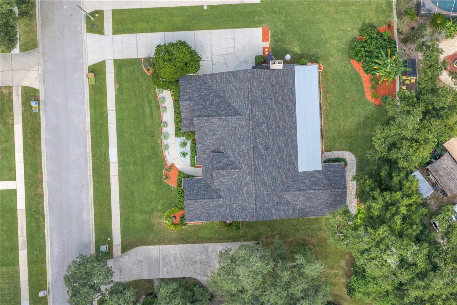 Recent improvements include an upgraded roof (2025), hurricane-rated windows, exterior doors, and garage door (2025) for added protection and peace of mind, the main HVAC system has been upgraded and air handler has been relocated out of the attic (2025), and two updated water heaters (2025). The kitchen features Bosch appliances, including a gas range (2023), along with updated lighting (2025). The septic system and drain field were replaced in 2020. - 2421 OAK LANDING DR, BRANDON