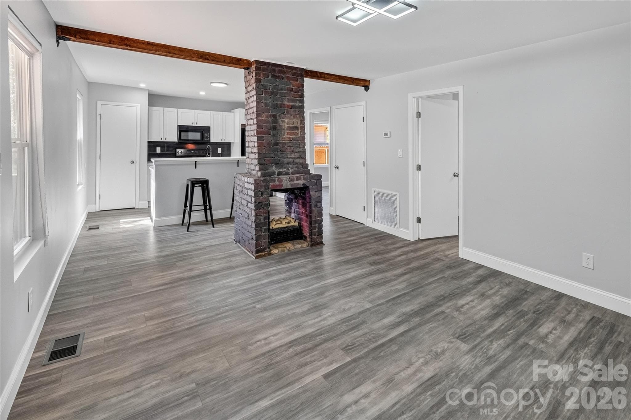 Plug in fireplace feature in open main living space. - 806 Cantwell Street, Charlotte