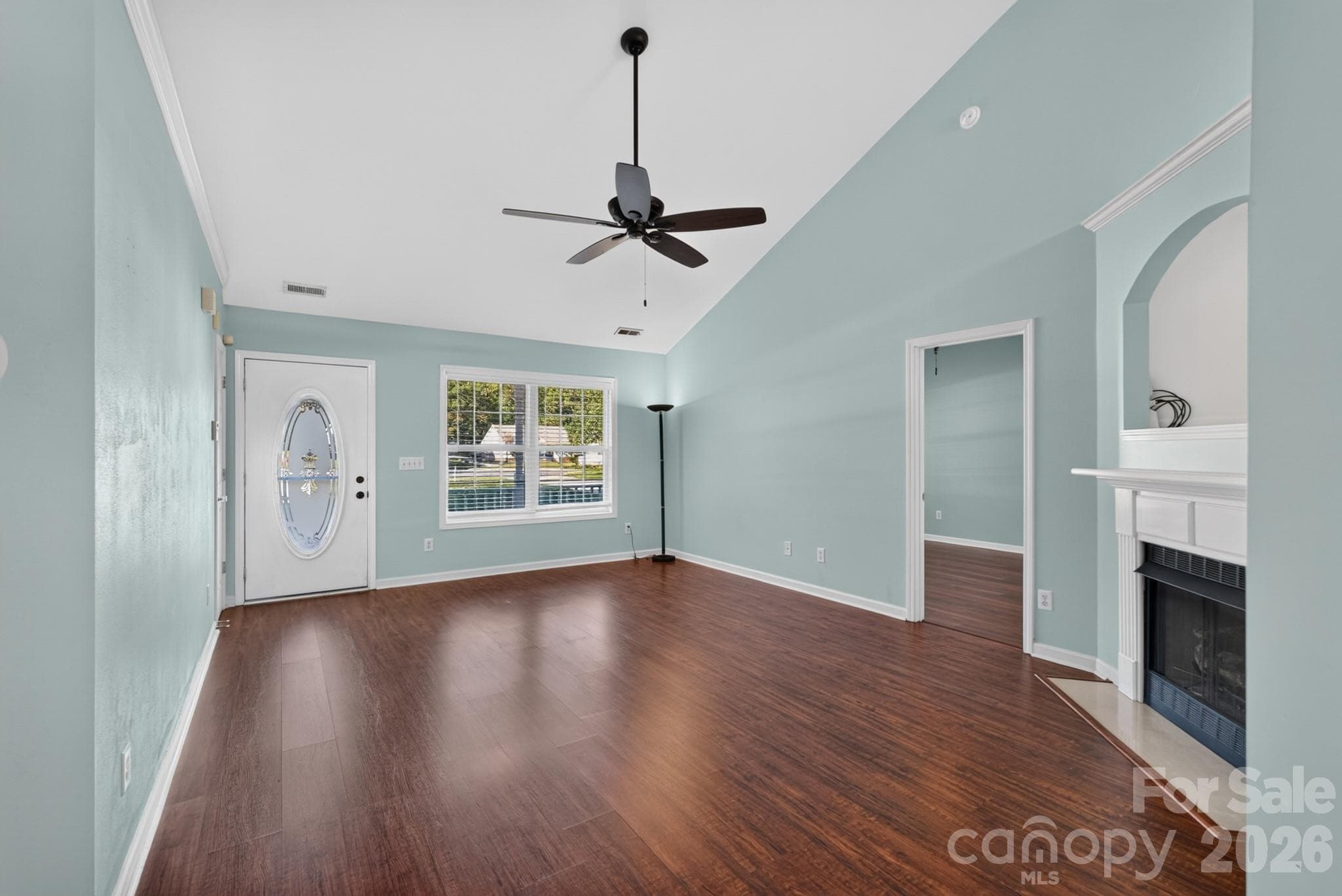 Cozy up in the central living room, centered around a focal fireplace and framed by large windows. - 702 Painted Lady Court, Rock Hill