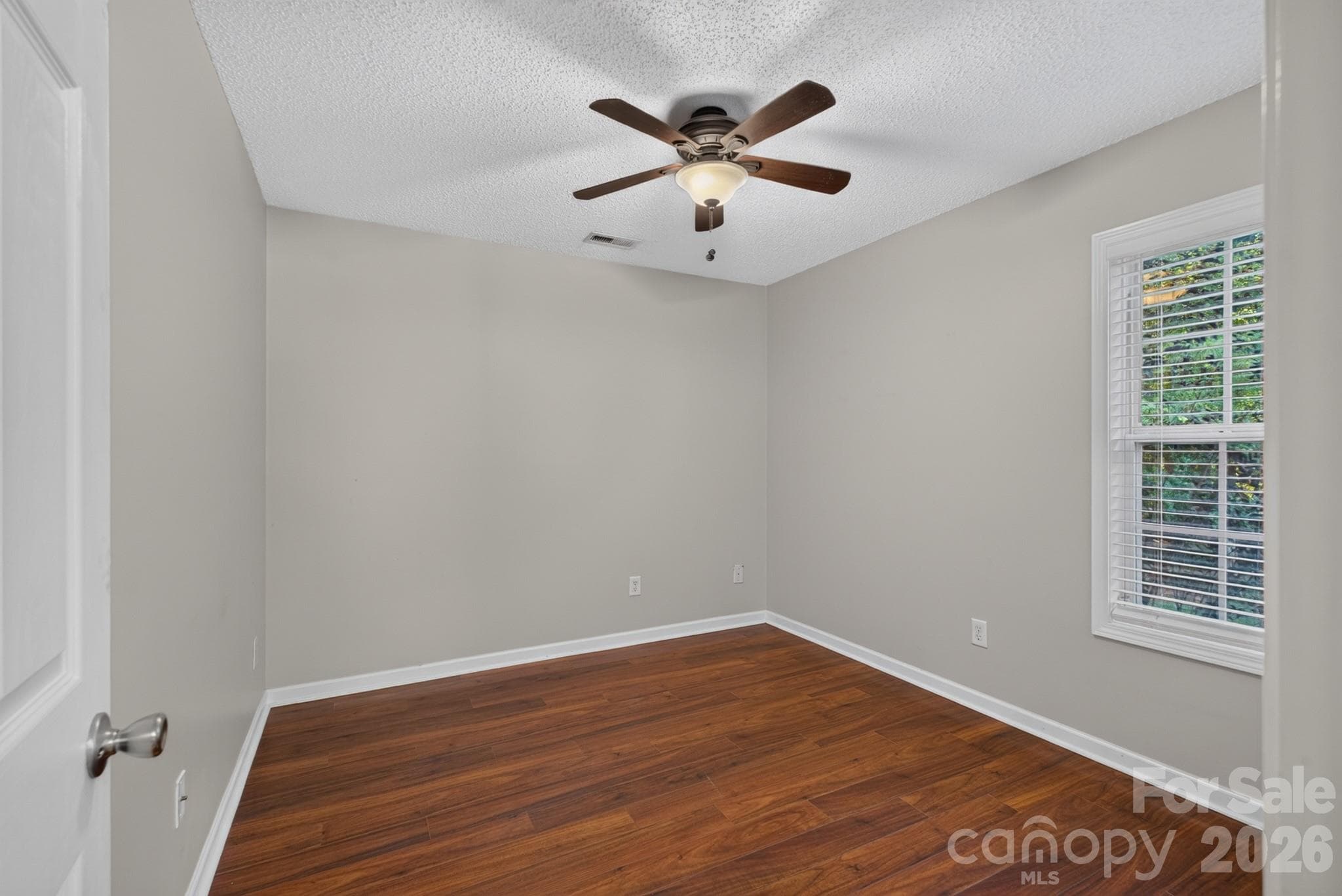 Beautiful hardwood flooring continues through this bright and cheery third bedroom. - 702 Painted Lady Court, Rock Hill
