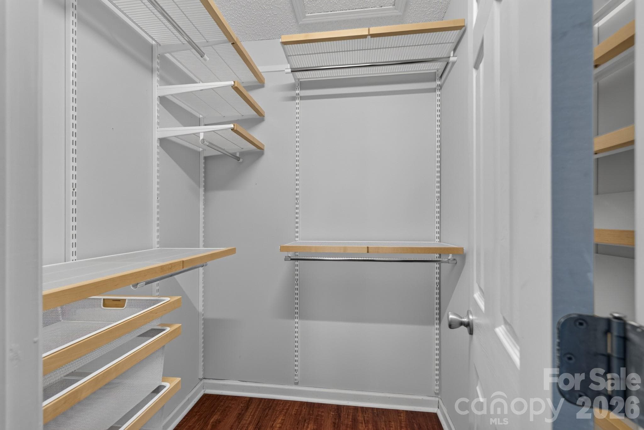 Generous walk-in closet with built-in custom wire shelving for maximum organization. - 702 Painted Lady Court, Rock Hill