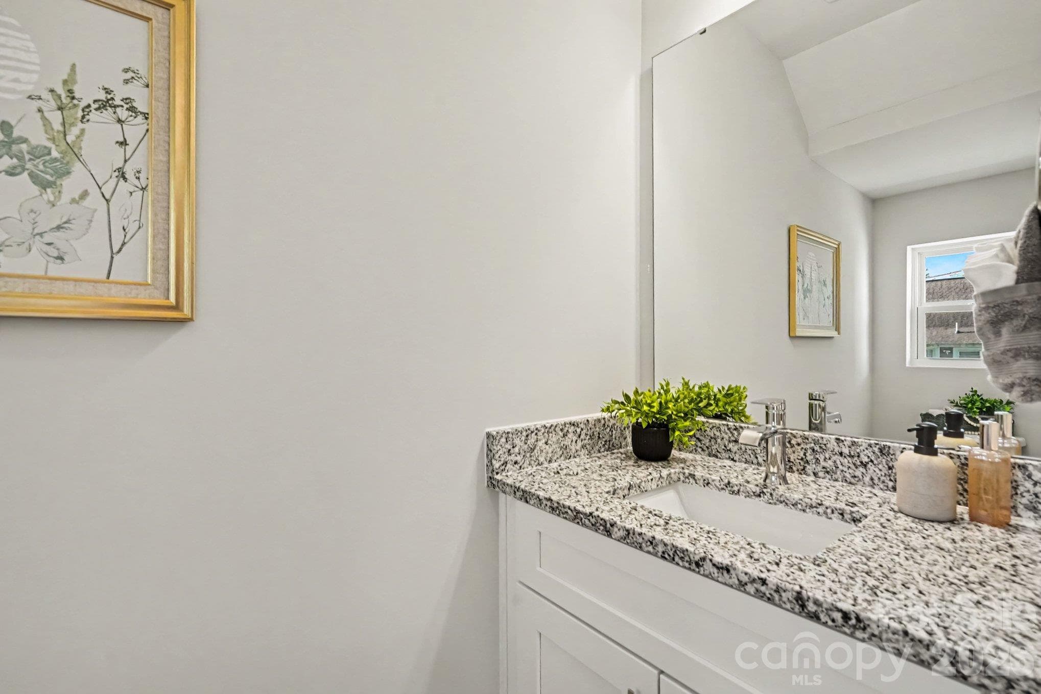 Half bathroom on main level hallway has a single vanity and granite countertop for a nice touch. This photo is a representation of home taken from identical home next door. Actual photos are in process. - 125 Buffalo Avenue NW, Concord