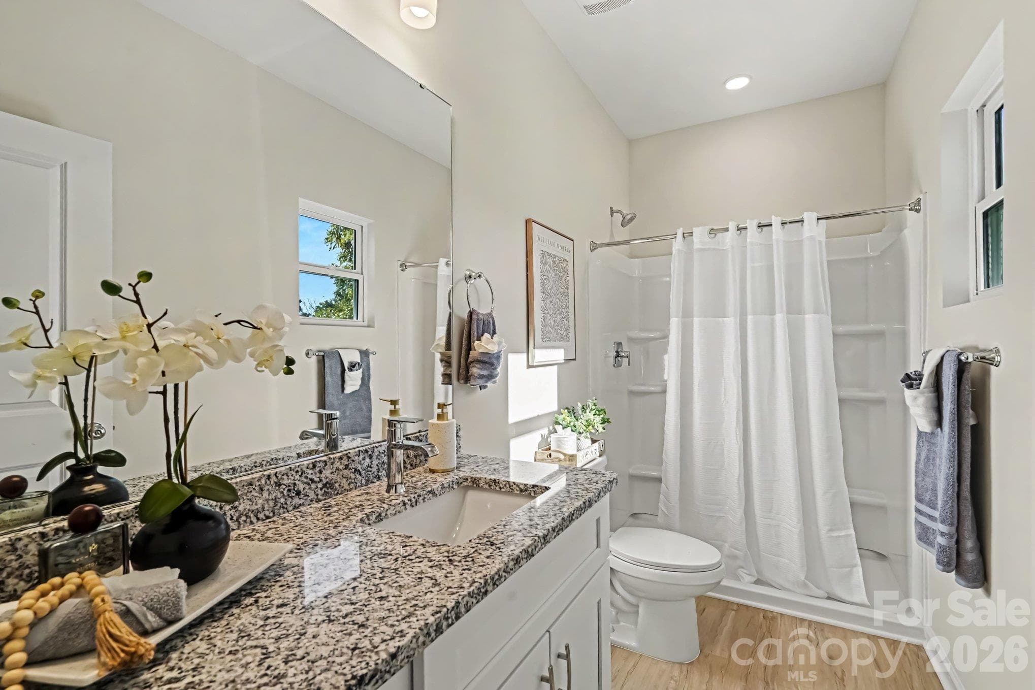 This is the primary owner's ensuite bathroom featuring a walk in shower, single vanity and an elegant granite countertop. This photo is a representation of home taken from identical home next door. Actual photos are in process. This photo is a representation of home taken from identical home next door. Actual photos are in process. - 125 Buffalo Avenue NW, Concord