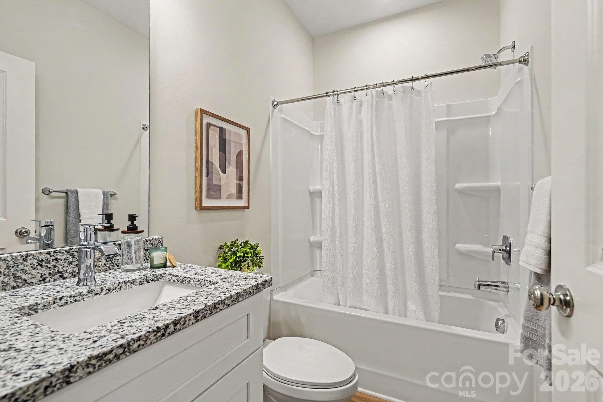 This is the hallway bathroom on upper level which features a shower/tub combo and granite countertop with single vanity. This photo is a representation of home taken from identical home next door. Actual photos are in process. - 125 Buffalo Avenue NW, Concord
