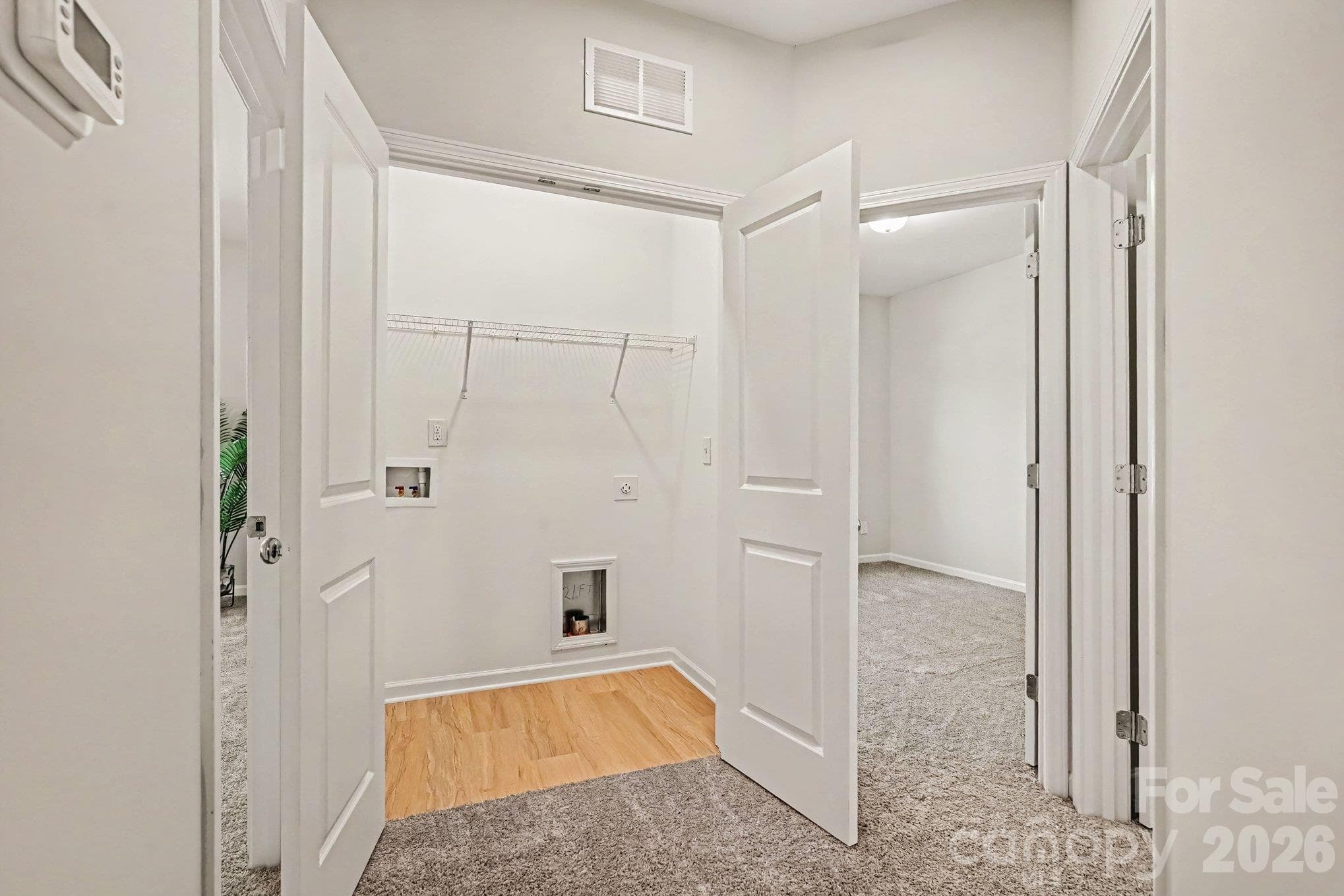 Laundry closet is on upper level near the bedrooms for convenience and efficient laundry work. - 125 Buffalo Avenue NW, Concord