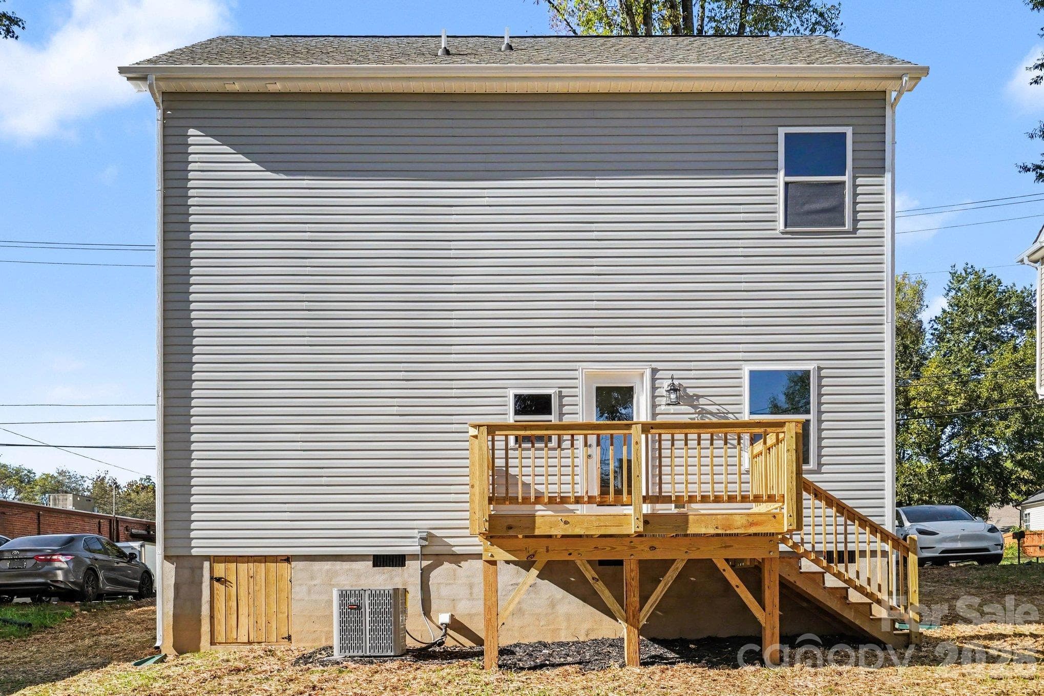 Back yard view with wooden deck. - 125 Buffalo Avenue NW, Concord