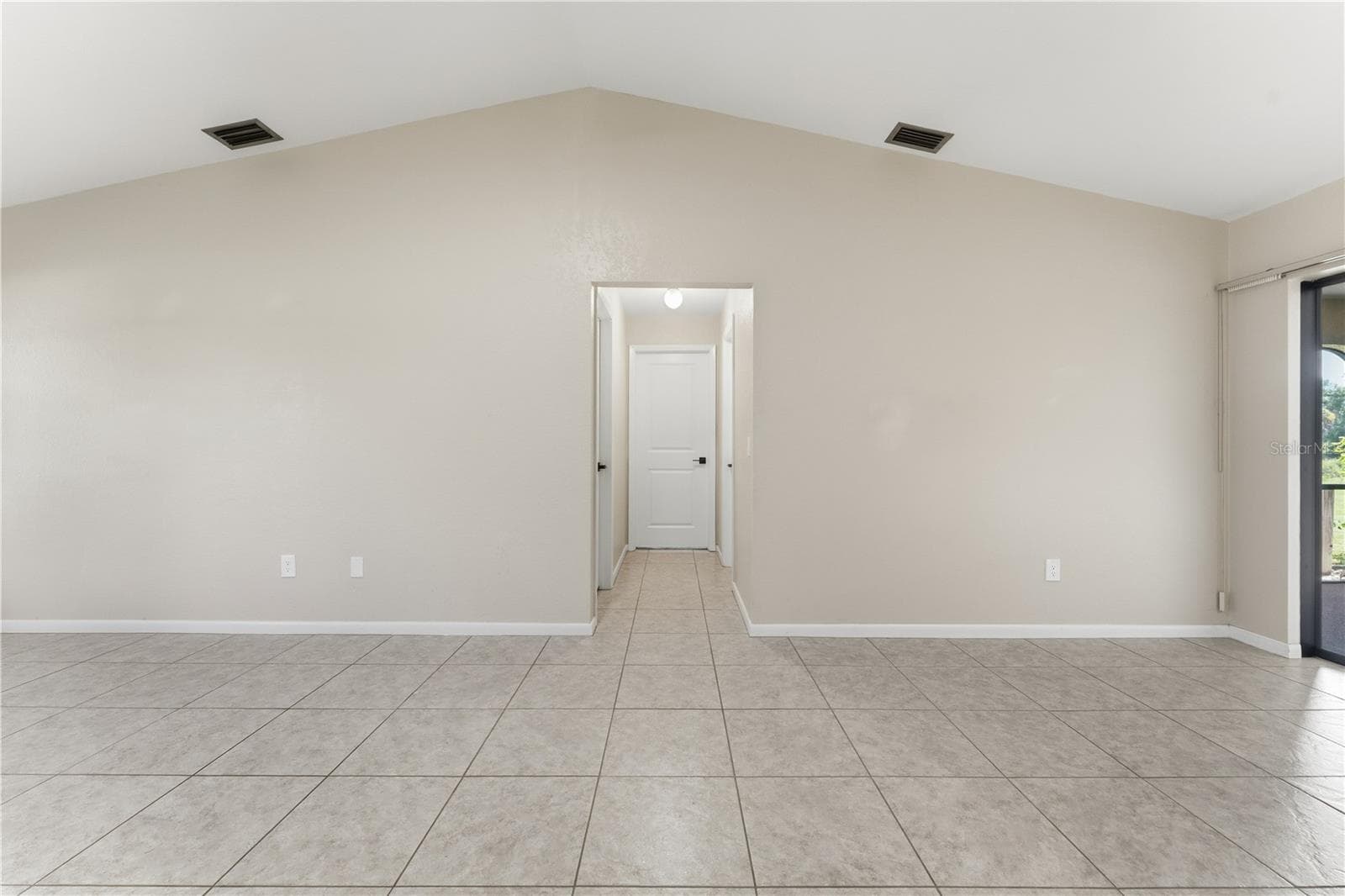 VEIW FROM KITCHEN TO BACK BEDROOMS AND GUEST BATH - 1478 NAVIGATOR RD, PUNTA GORDA