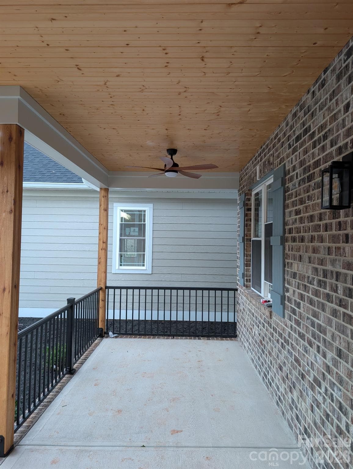 Front porch with wood ceilings and ceiling fan - 1895 Knolls Drive, Newton