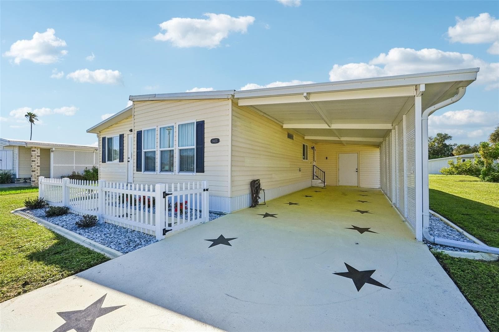 Long drive-way with covered carport and shed with laundry - 8455 ALBATROSS LN, ENGLEWOOD