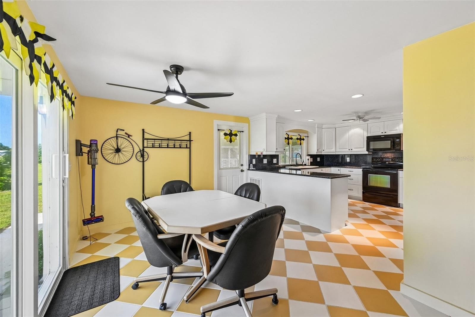 Open kitchen with stone counters right inside the front door - 8455 ALBATROSS LN, ENGLEWOOD