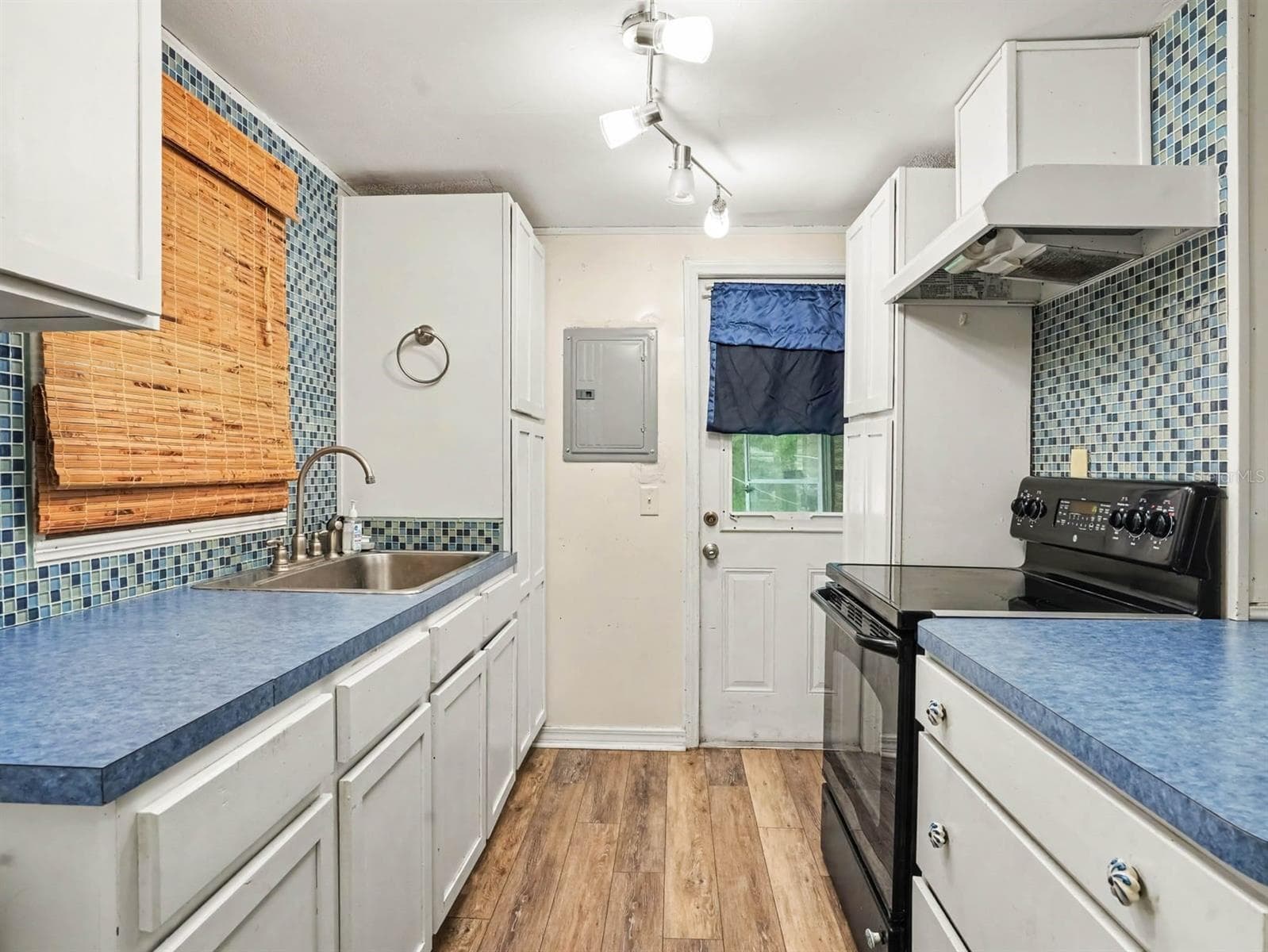 Galley Kitchen with Double Sink & Black Gas Range - 3015 STRAWBERRY LN, LAKELAND