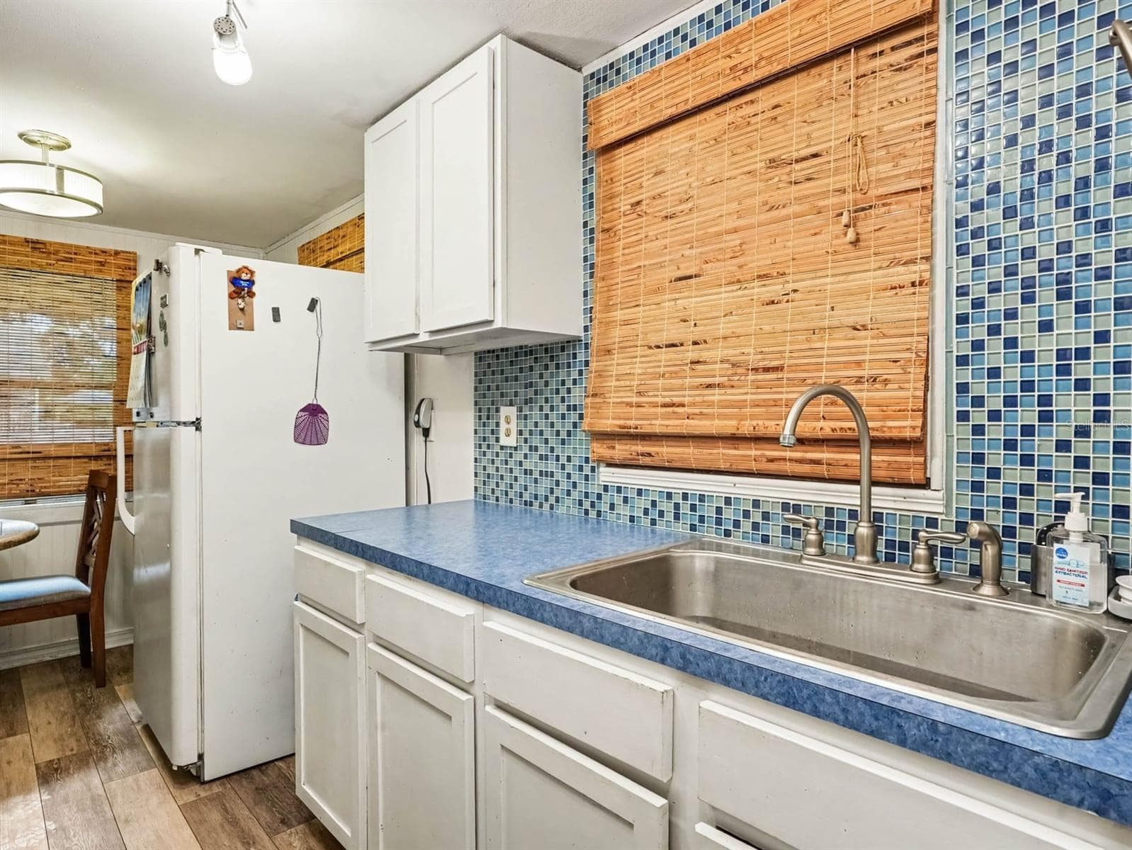 Updated Kitchen with Blue Tile Backsplash, Stainless Steel Sink & Modern Appliances - 3015 STRAWBERRY LN, LAKELAND