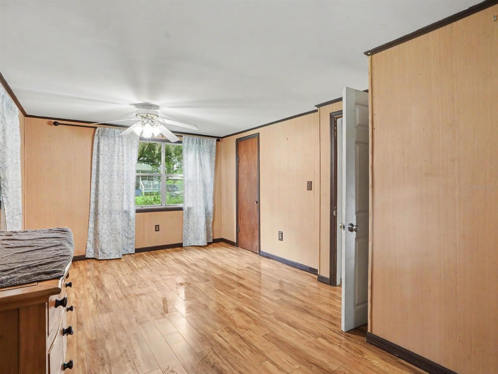 Comfortable Bedroom with Wood Floors, Window Seat & Direct Patio Access - 3015 STRAWBERRY LN, LAKELAND