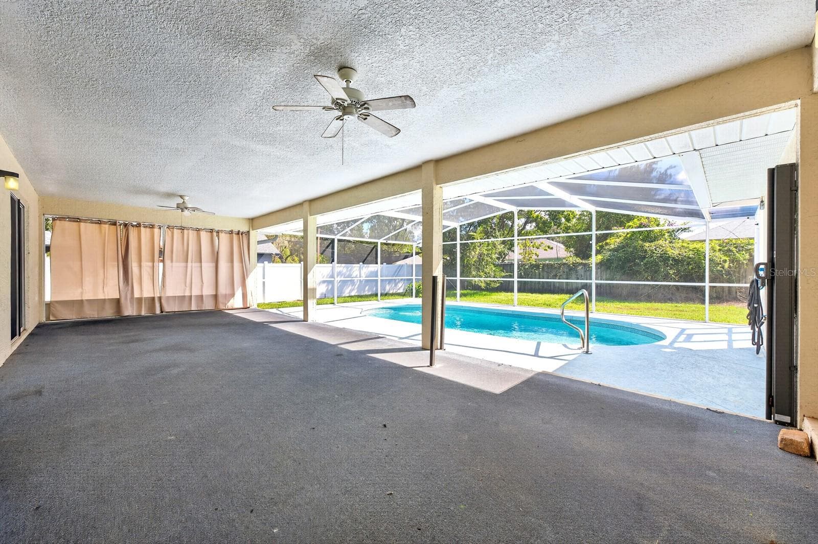 Large covered lanai overlooks the private screened pool and fully fenced backyard. - 32919 INDIAN WOODS DR, LEESBURG