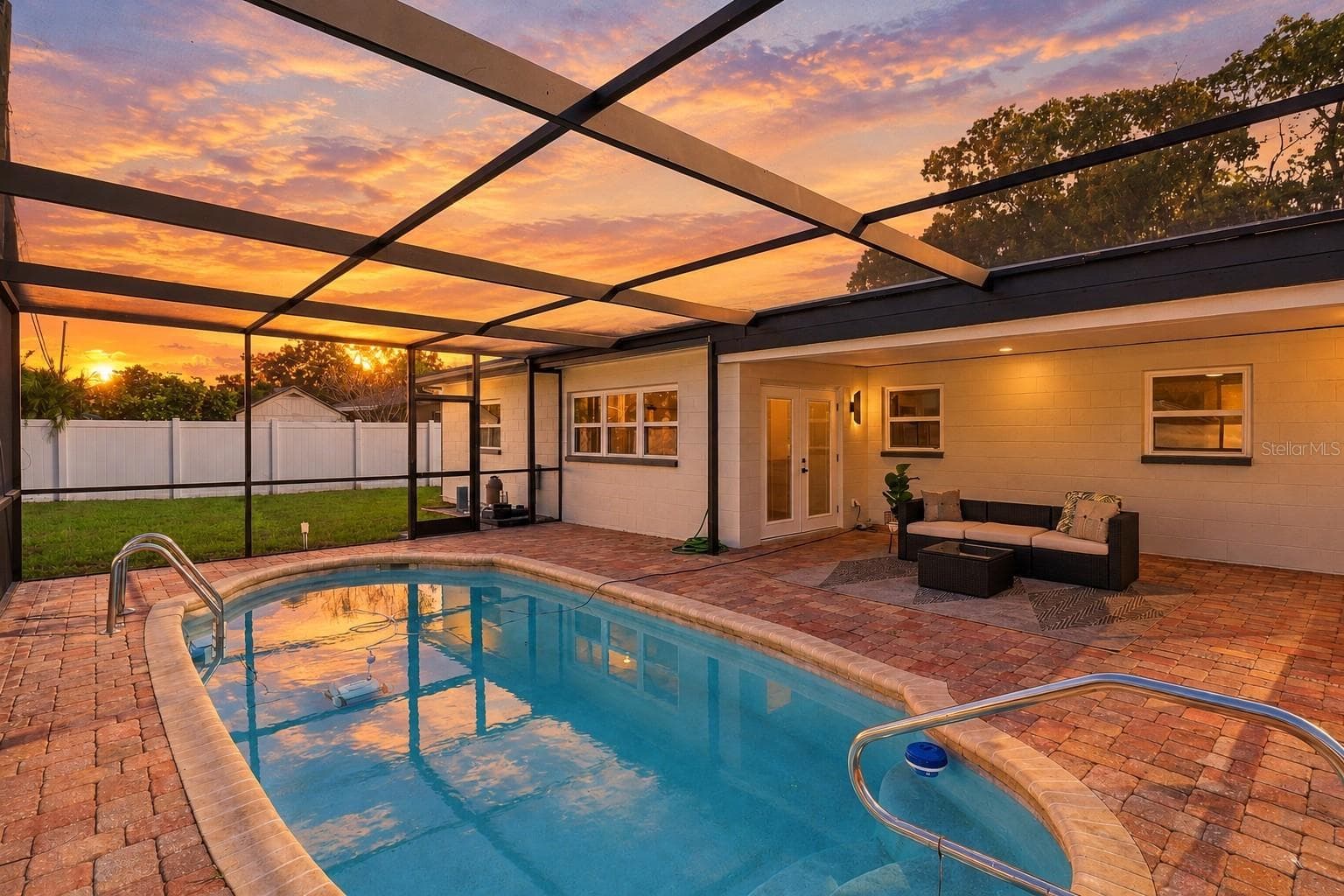 Enjoy beautiful Florida sunsets from your private screened-in pool and spacious paver patio, the perfect setting for relaxing, entertaining, and enjoying outdoor living year-round. - 11218 116TH ST, SEMINOLE
