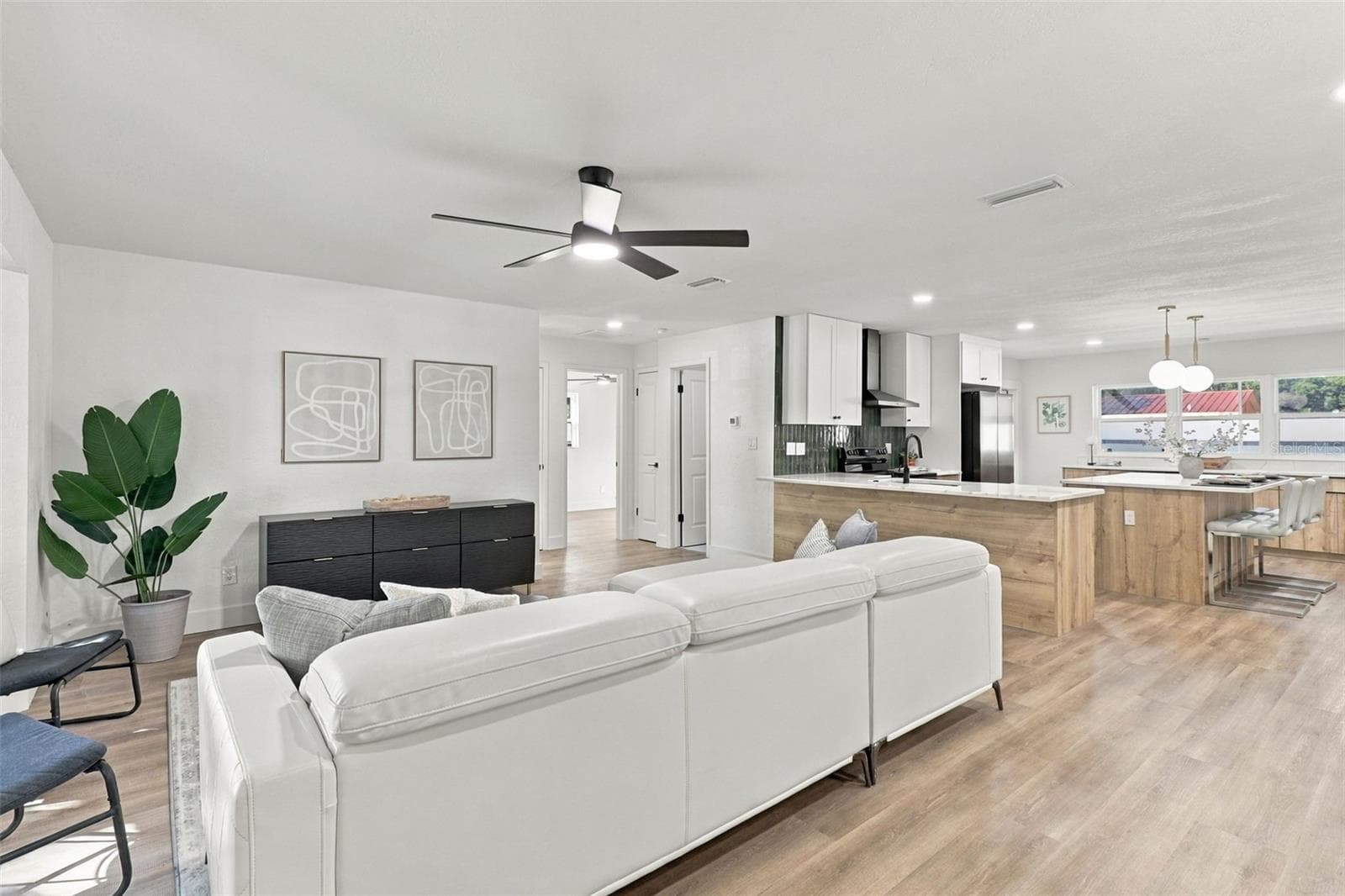 Step inside to a welcoming living room that flows seamlessly into the beautifully updated kitchen, creating an inviting and functional space perfect for everyday living and entertaining. - 11218 116TH ST, SEMINOLE