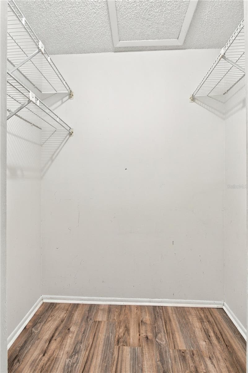Primary bedroom walk-in closet provides plenty of space. - 9911 LANCEWOOD ST, ORLANDO