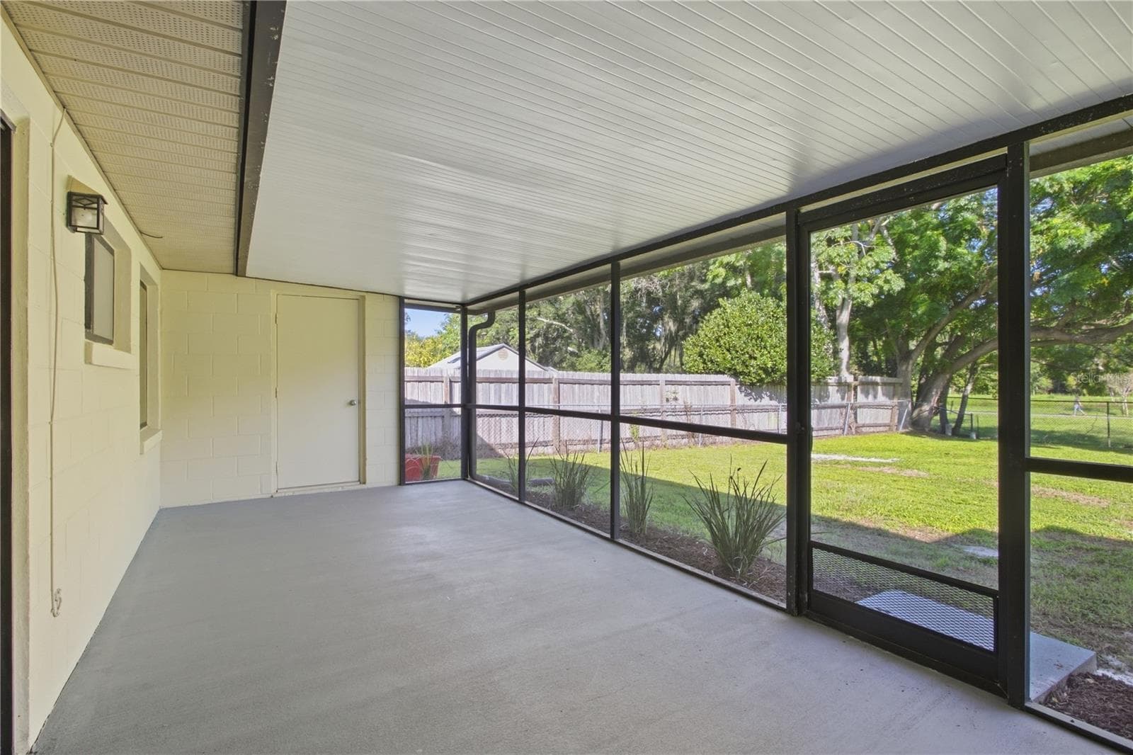 Spacious back porch includes utility closet with hookup for washer and dryer. - 9911 LANCEWOOD ST, ORLANDO