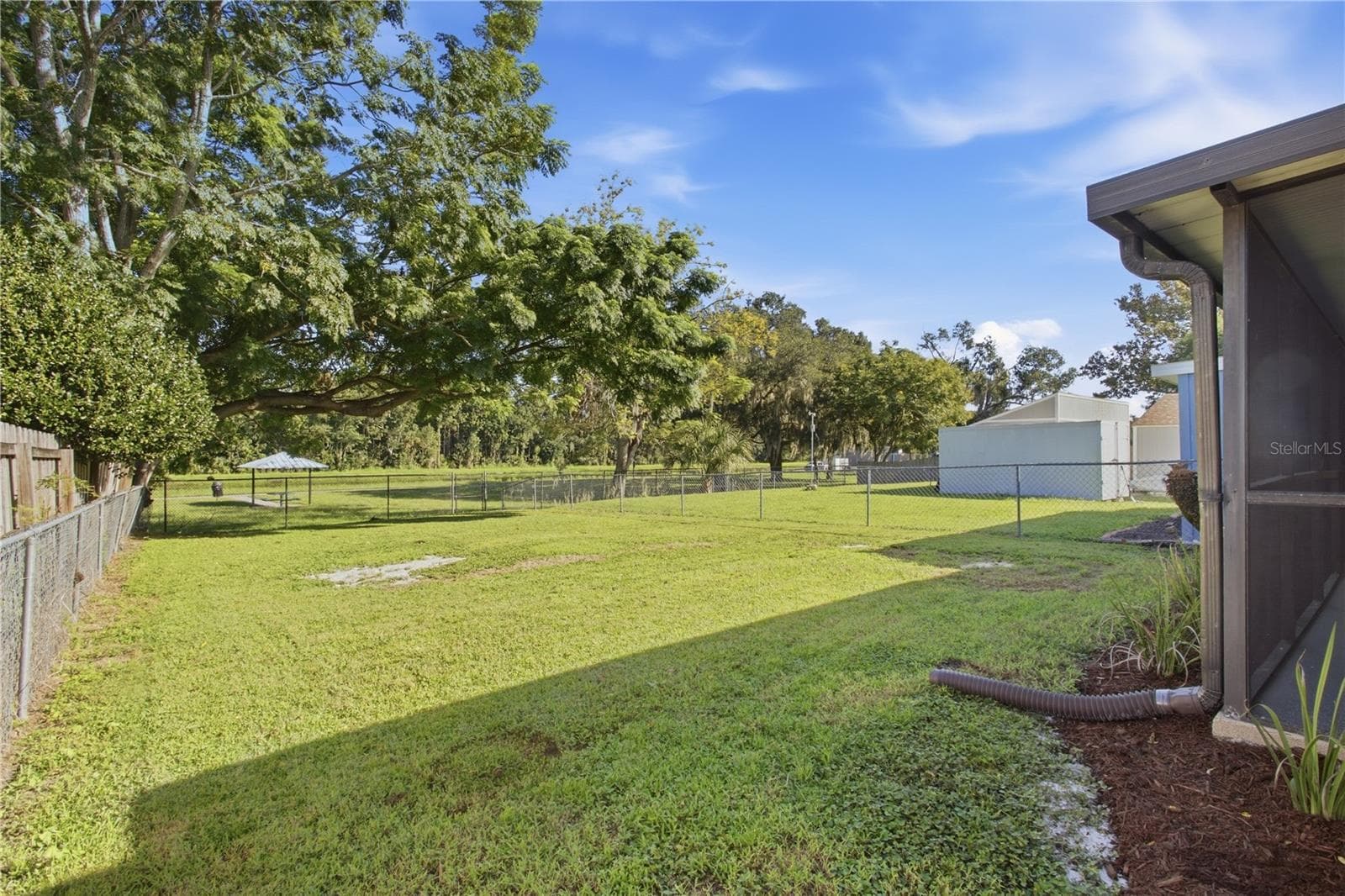 Mature trees at end of backyard with picnic table and cool breezes from the river - 9911 LANCEWOOD ST, ORLANDO