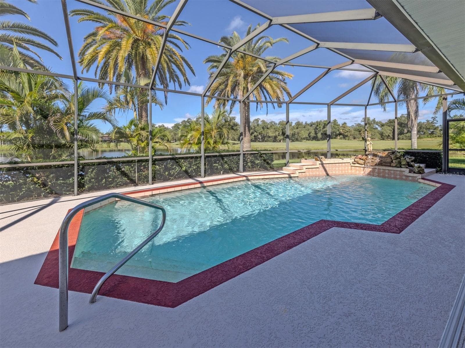 The large pool includes a waterfall and overlooks the beautiful pond and golf course - 1725 ARDRY WAY, VENICE