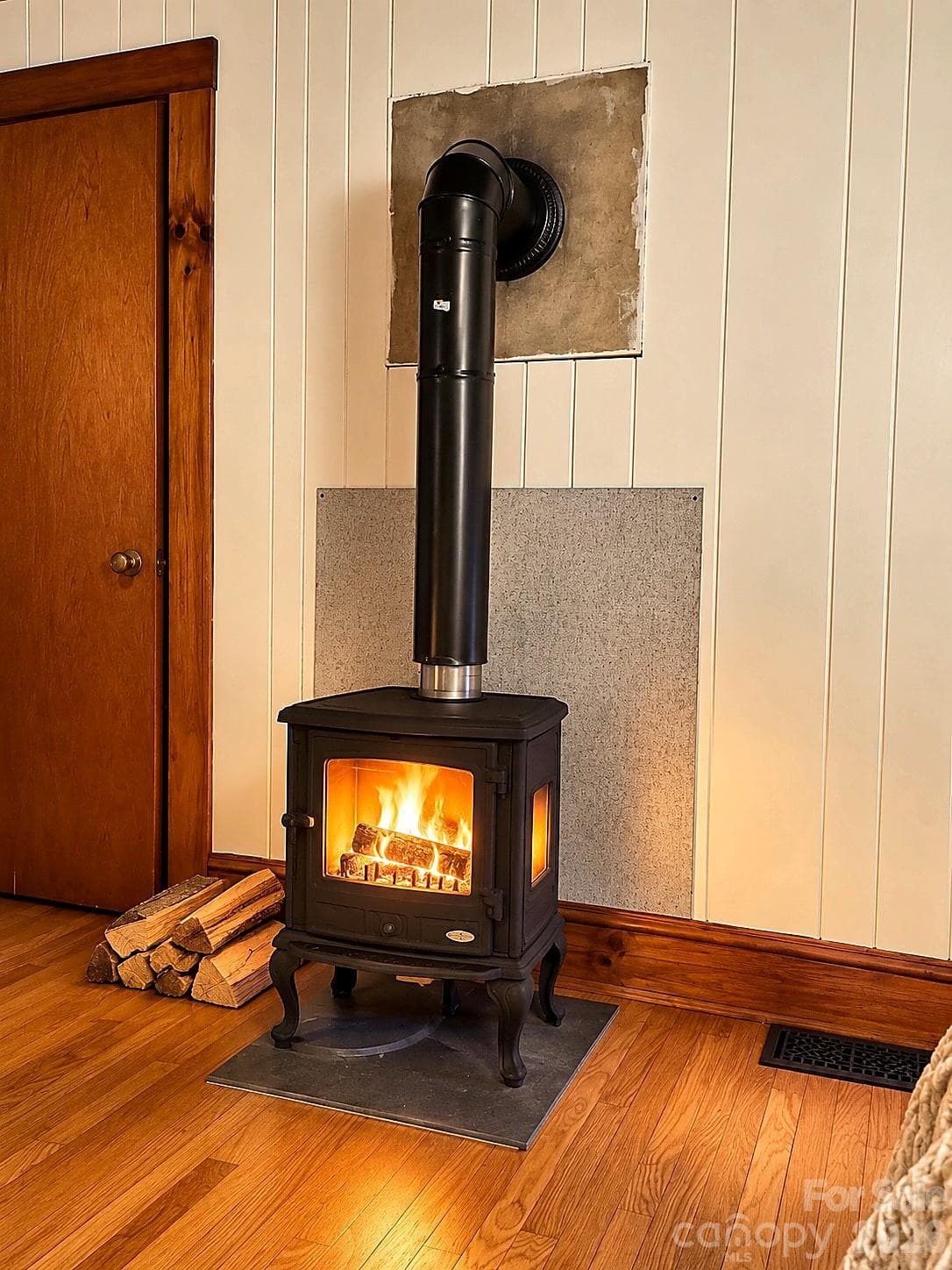 Primary Bedroom wood stove(enhanced with fire) - 683 McDaniel Road, Lake Lure