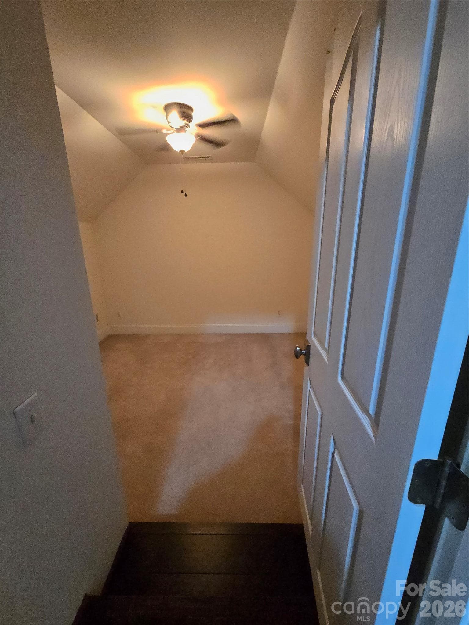 Step down into extra room (no window) with a closet and access to floored attic space off from the bonus area - 3008 Scottsdale Lane, Matthews