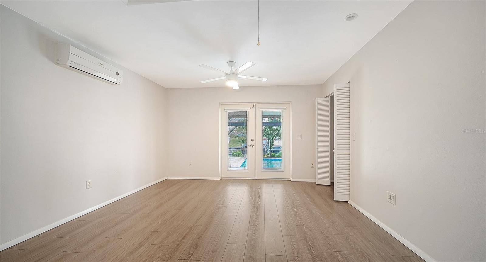 French doors bring the poolside lifestyle close to your primary bedroom. - 4907 CORAL BLVD, BRADENTON