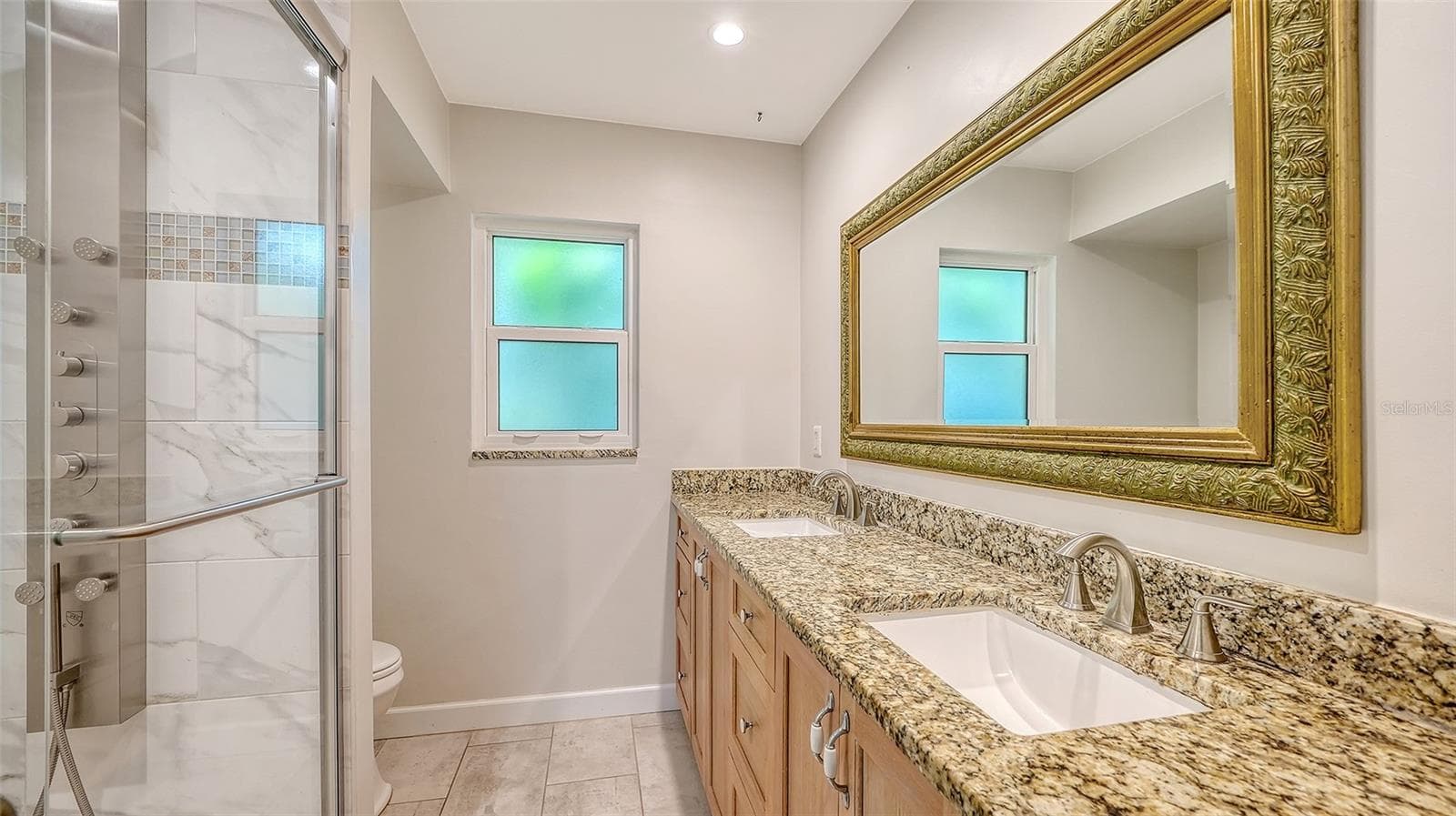 A spacious vanity and glass shower for daily comfort. - 4907 CORAL BLVD, BRADENTON
