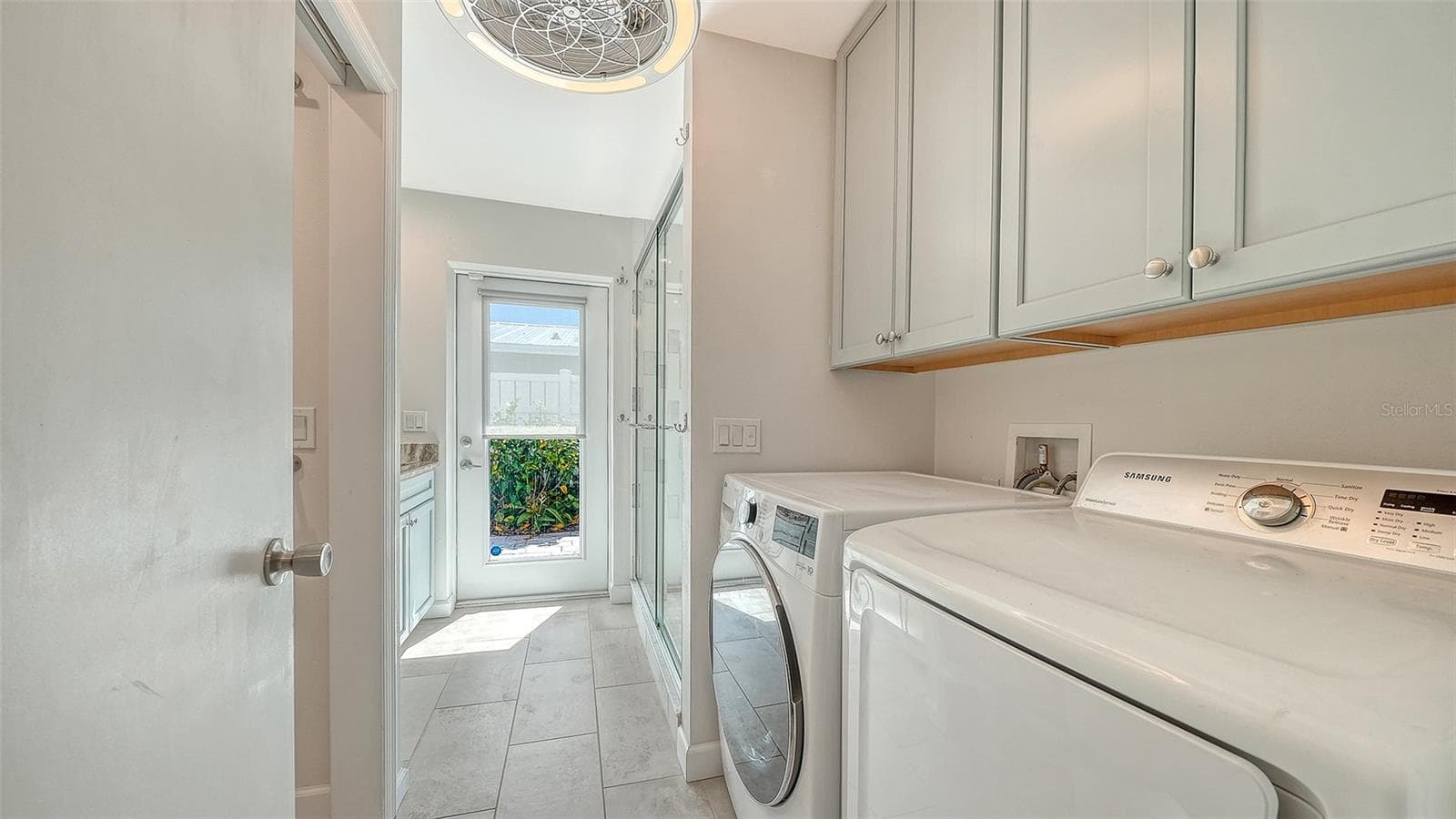 A dedicated laundry area with overhead cabinetry. - 4907 CORAL BLVD, BRADENTON
