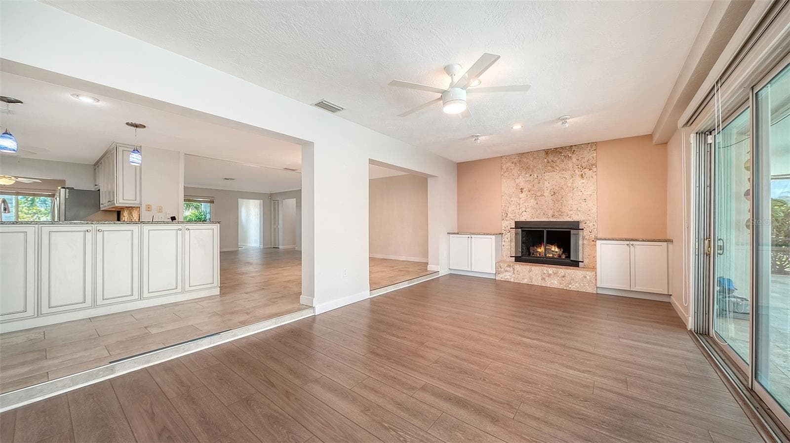 A fireplace adds warmth to the connected living space. - 4907 CORAL BLVD, BRADENTON