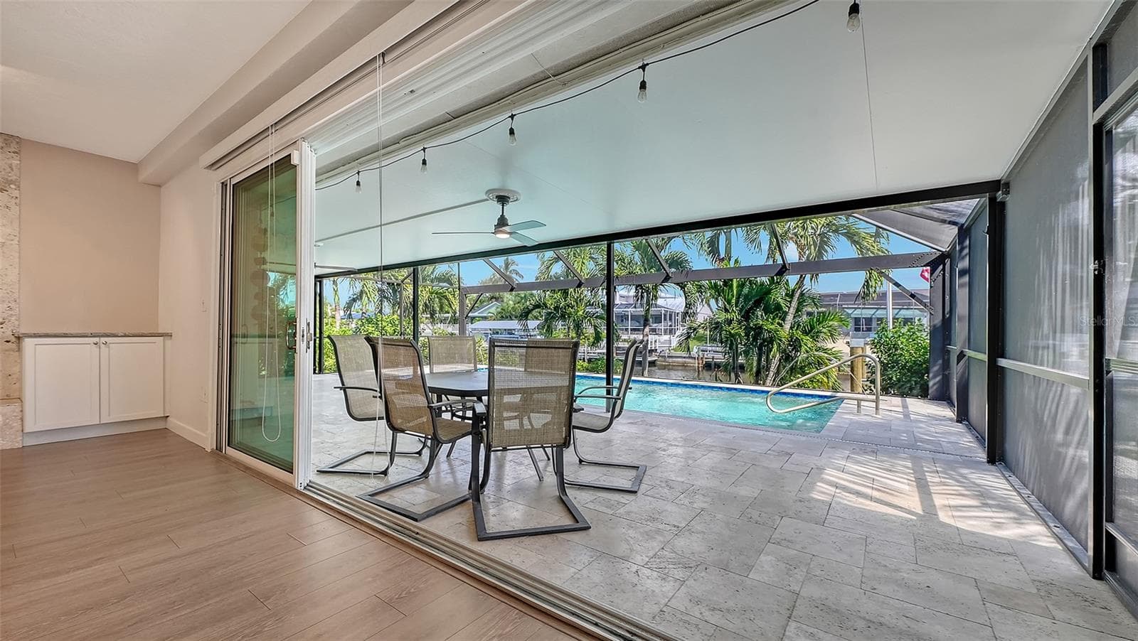 Retractable sliding doors connect indoor comfort and outdoor relaxation. - 4907 CORAL BLVD, BRADENTON