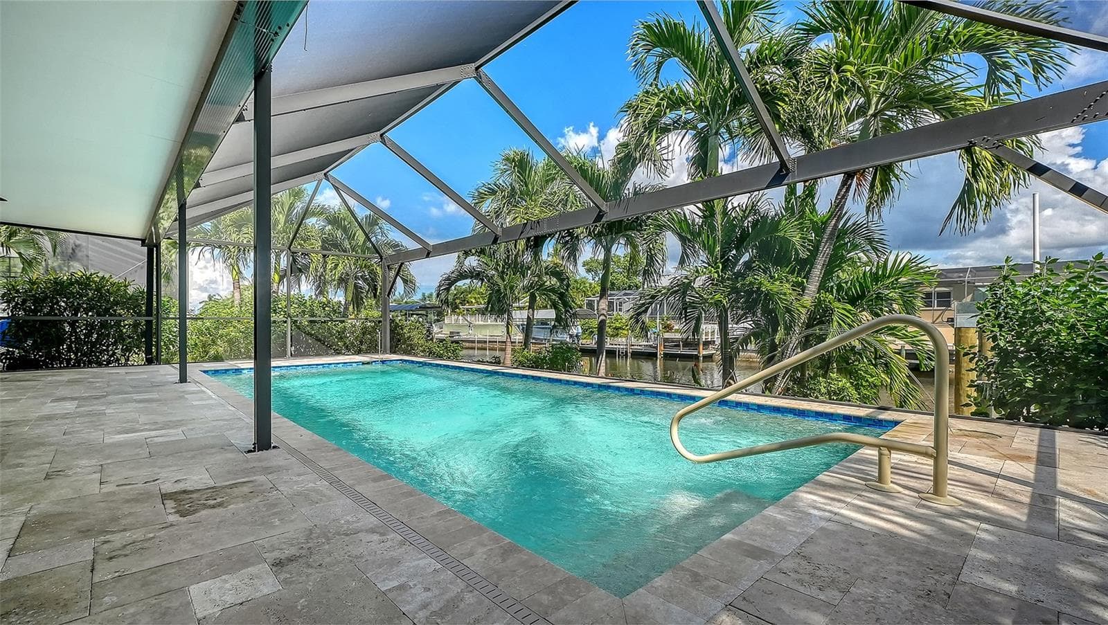 Tropical greenery surrounds your screened pool retreat for privacy. - 4907 CORAL BLVD, BRADENTON