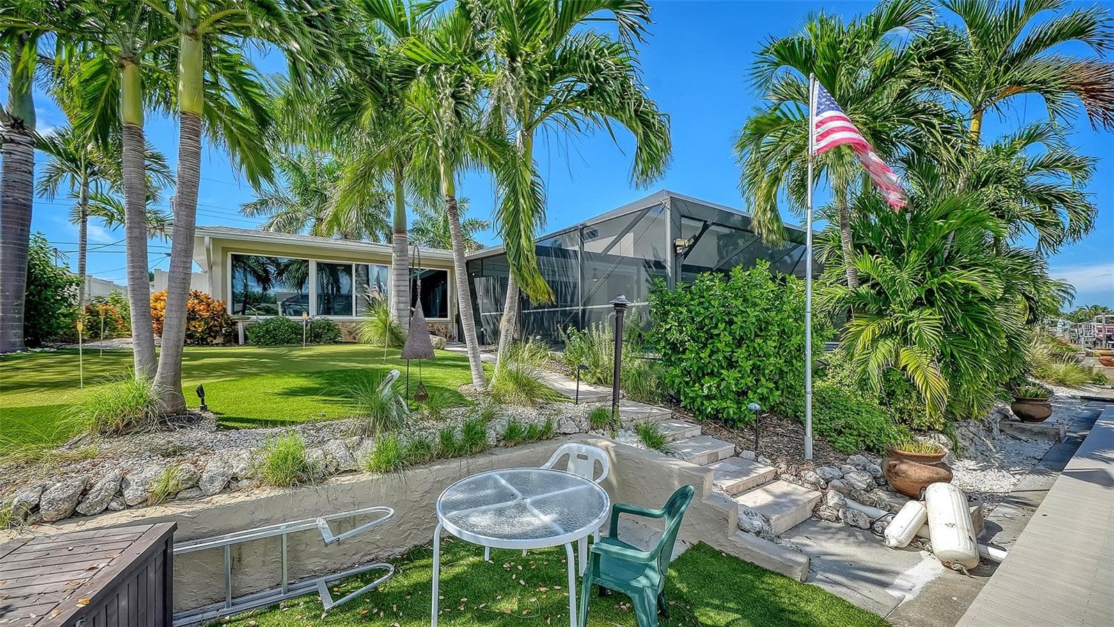 Enjoy a relaxed waterside seat beneath the palms. - 4907 CORAL BLVD, BRADENTON