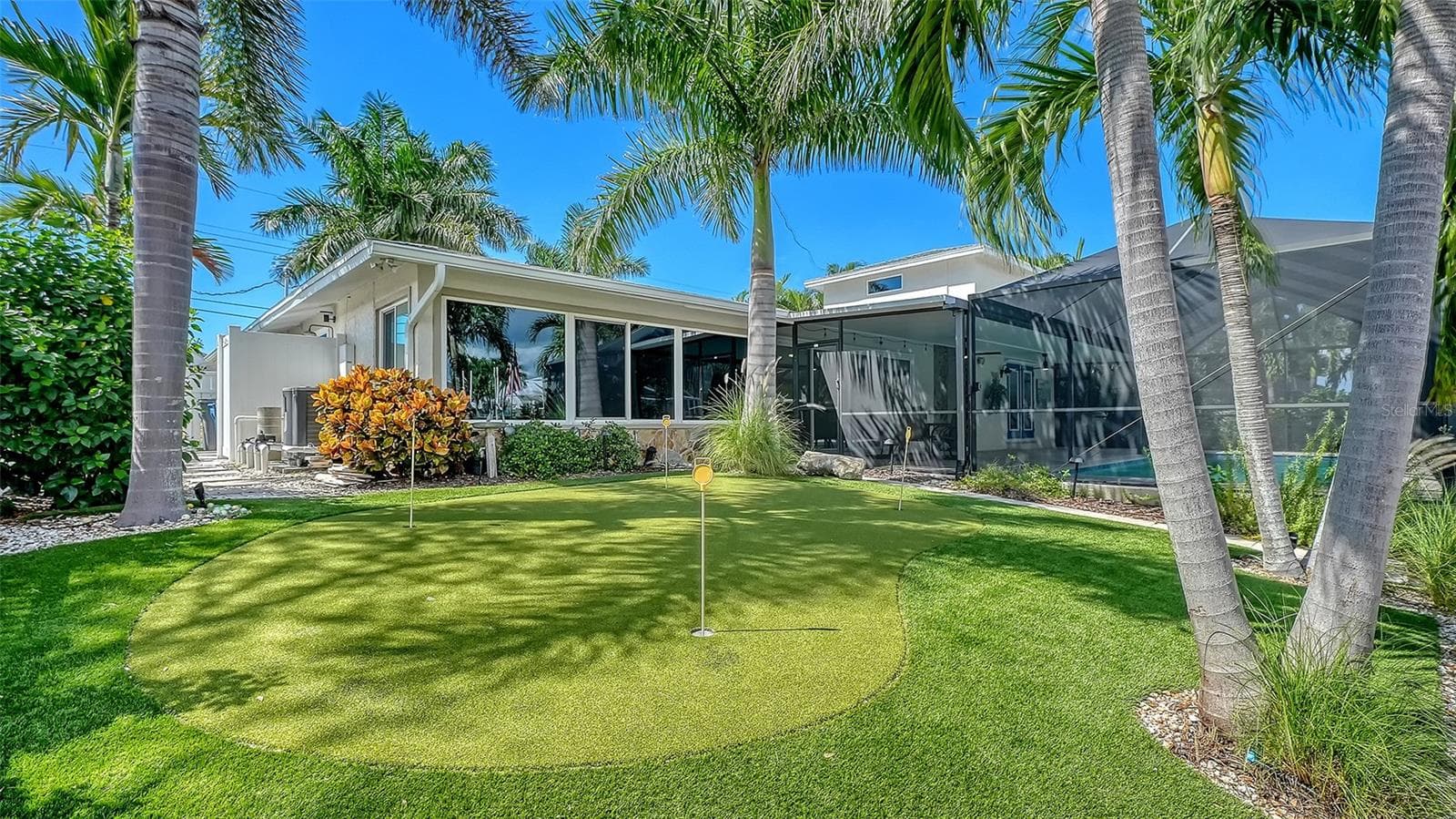 A backyard putting green adds another way to enjoy the outdoors. - 4907 CORAL BLVD, BRADENTON