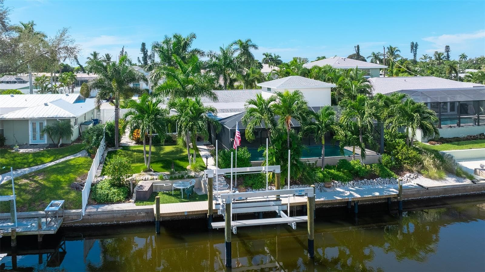 Your saltwater waterfront retreat, with a pool, dock, golf and tropical landscaping. - 4907 CORAL BLVD, BRADENTON