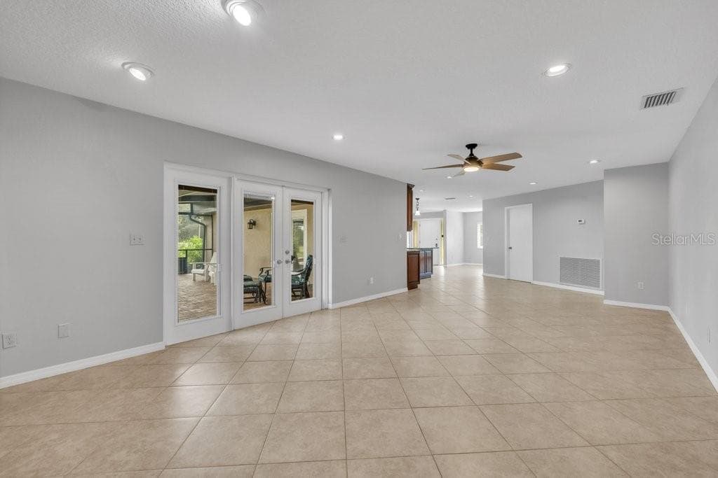 Great room with access to the pool area through the french doors - 5710 WO GRIFFIN RD, PLANT CITY